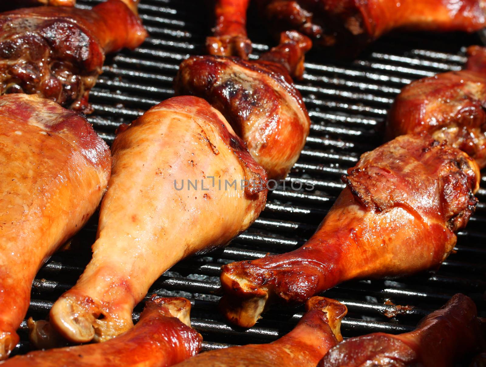 Fresh and juicy turkey legs on open grill