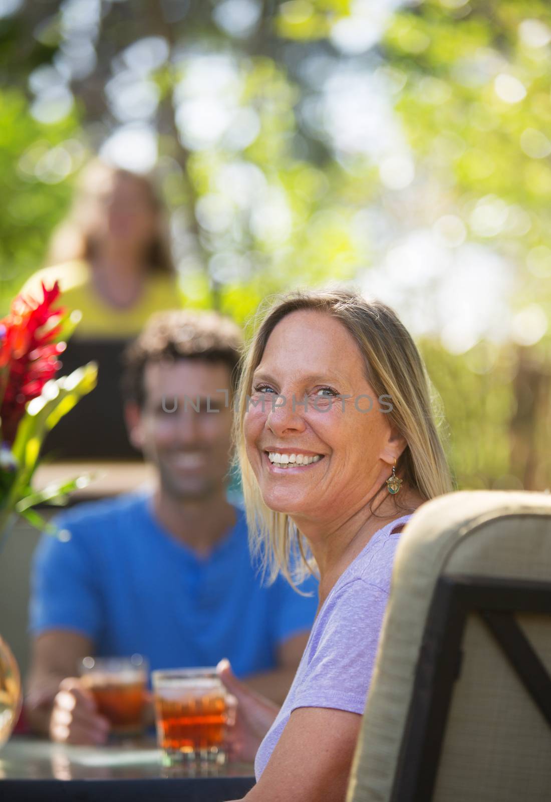 Attractive woman with friend on vacation at table