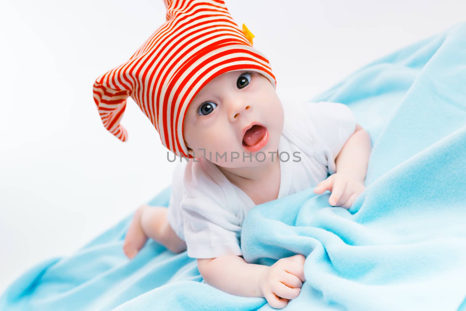 toddler in a striped hat on a blue blanket by pzRomashka