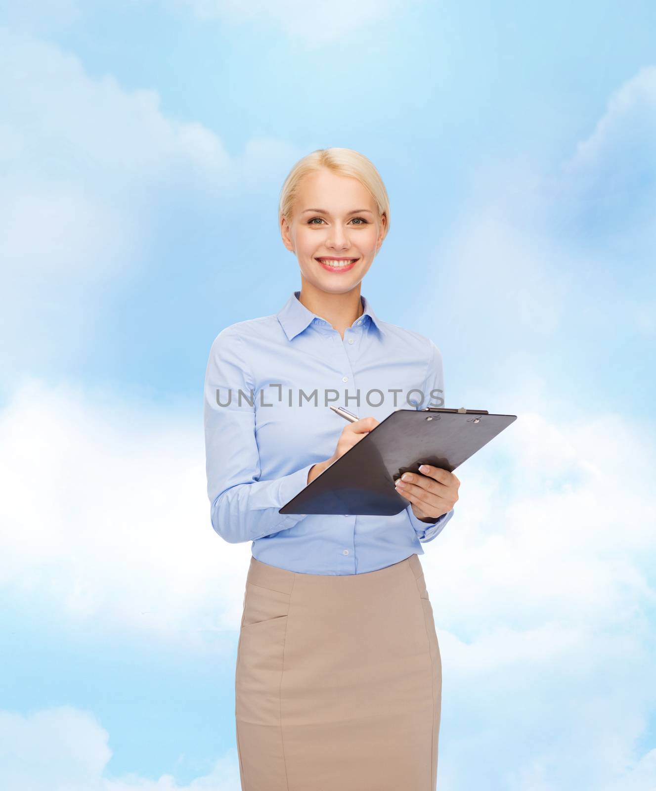 smiling businesswoman with clipboard and pen by dolgachov