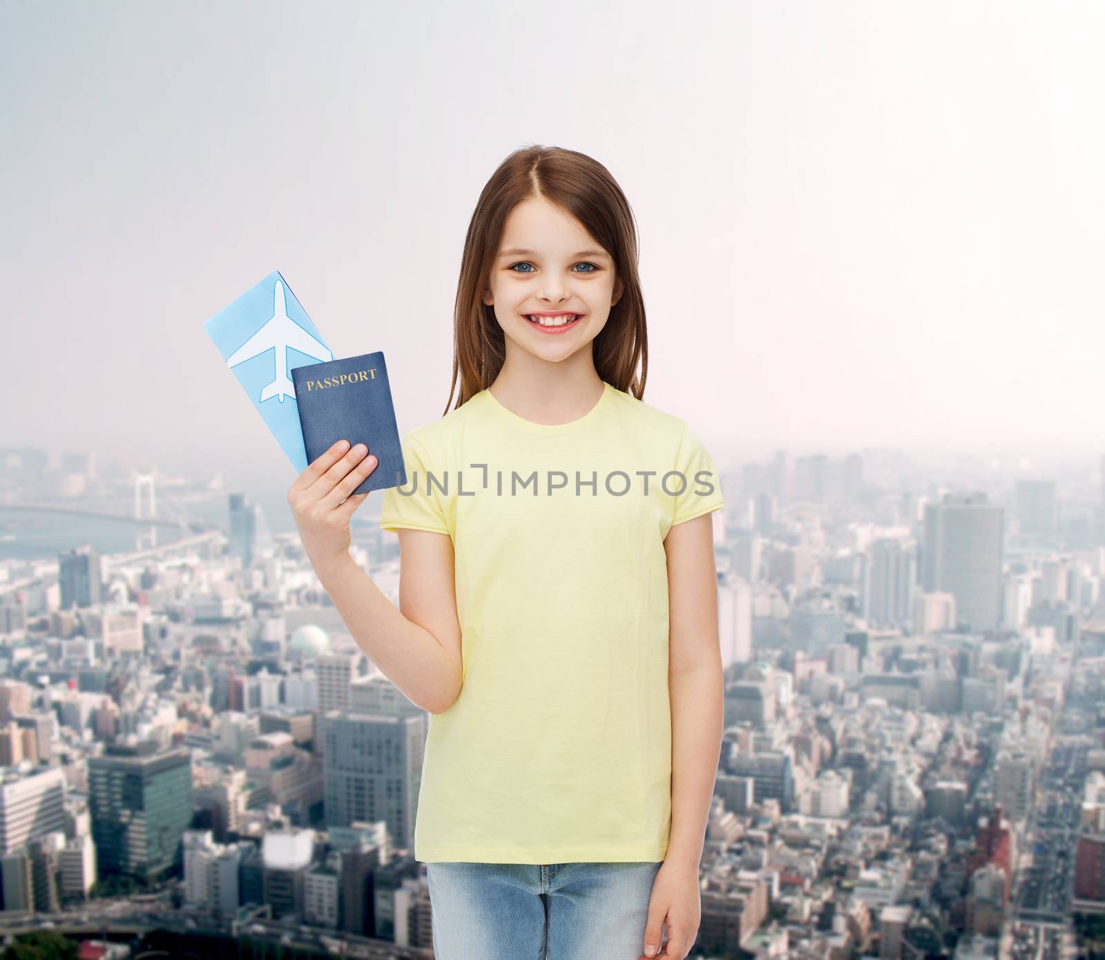 travel, holiday, vacation, childhood and transportation concept - smiling little girl with airplane ticket and passport