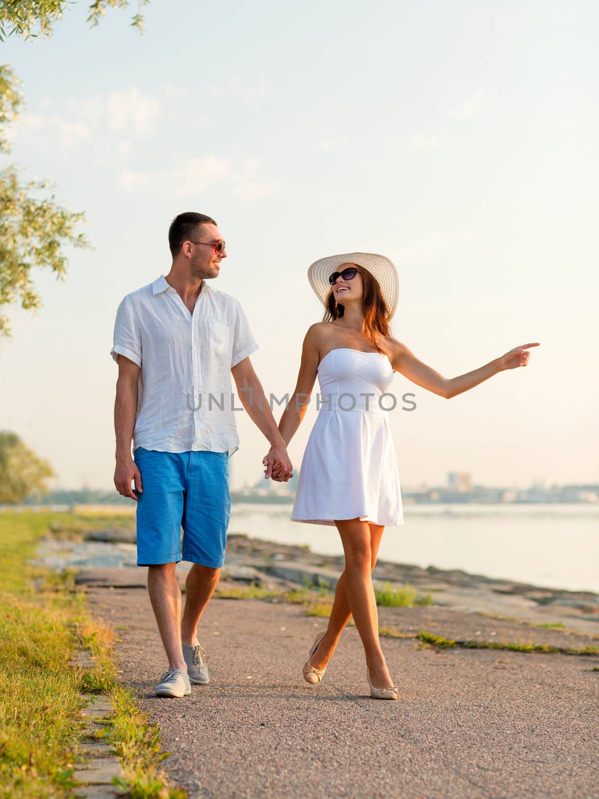 smiling couple walking outdoors by dolgachov