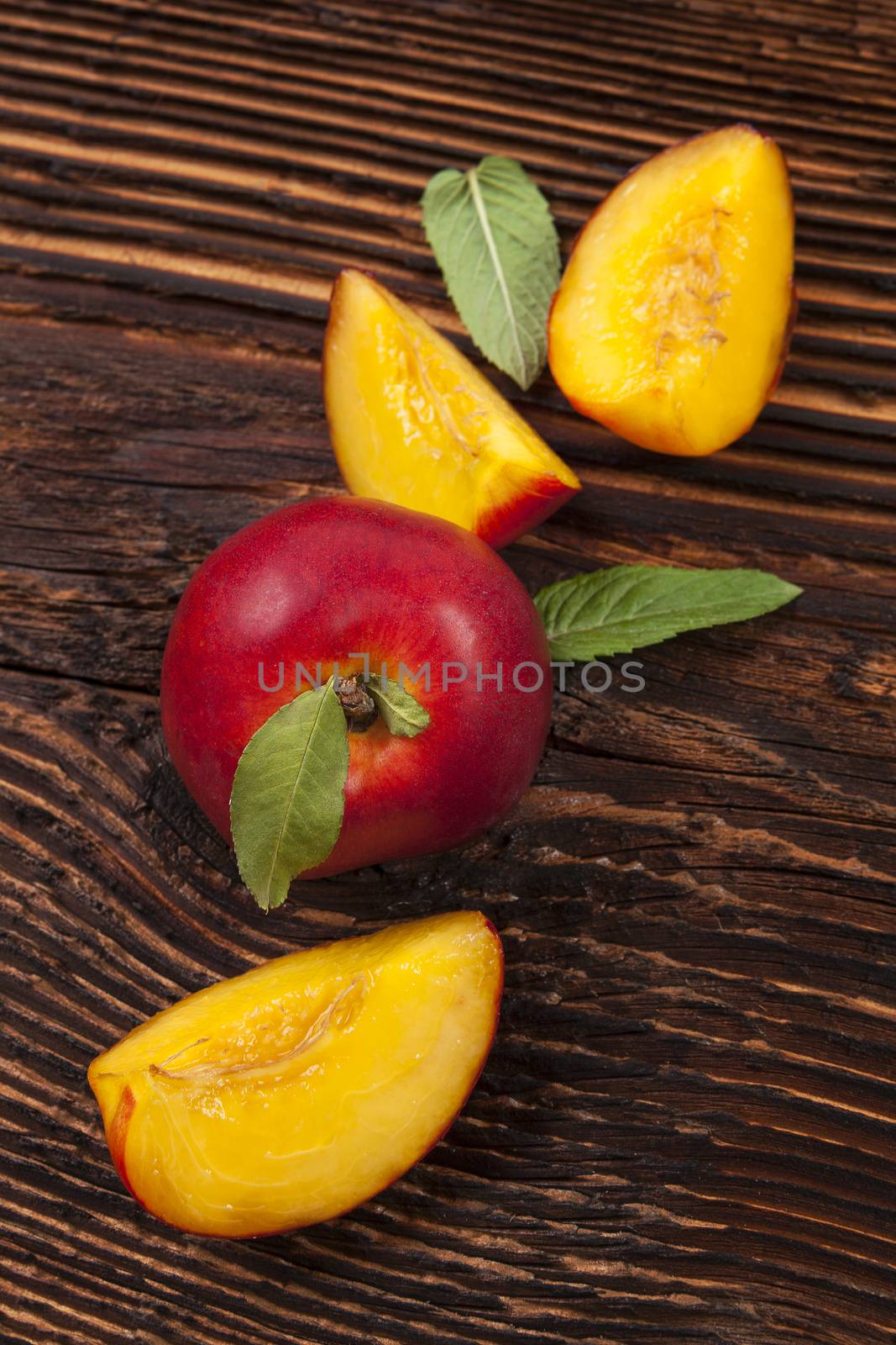 Fresh ripe nectarines background on wooden rustic table. Healthy fresh ripe fruit eating. 