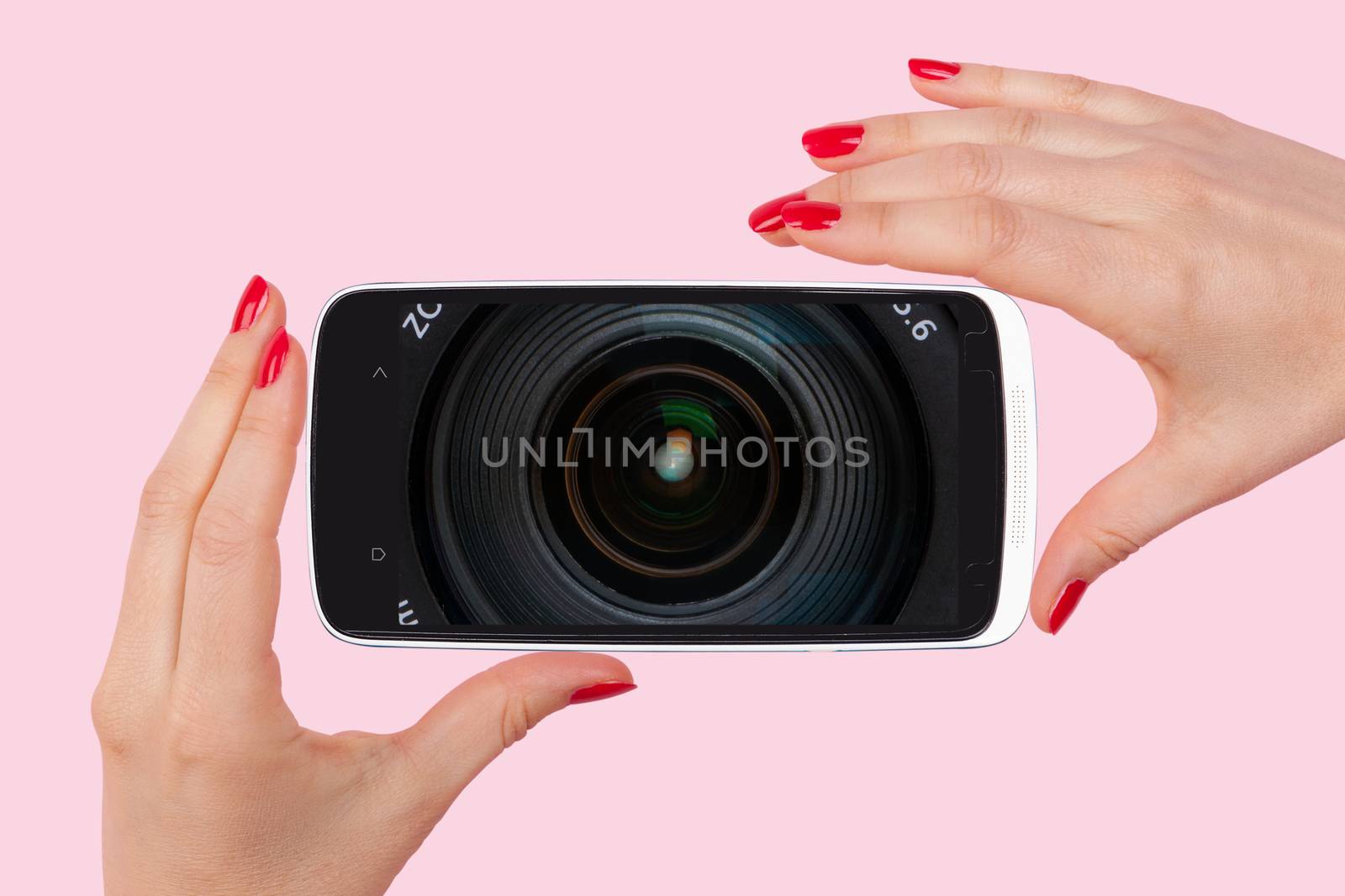 Selfie. Female hands with red nails holding smartphone with optical lens on screen. Modern social media picture communication.