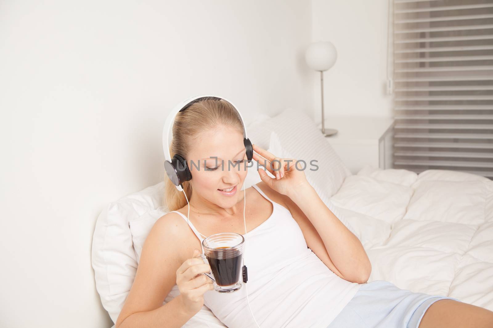 Pretty woman listening to music and drinking coffe