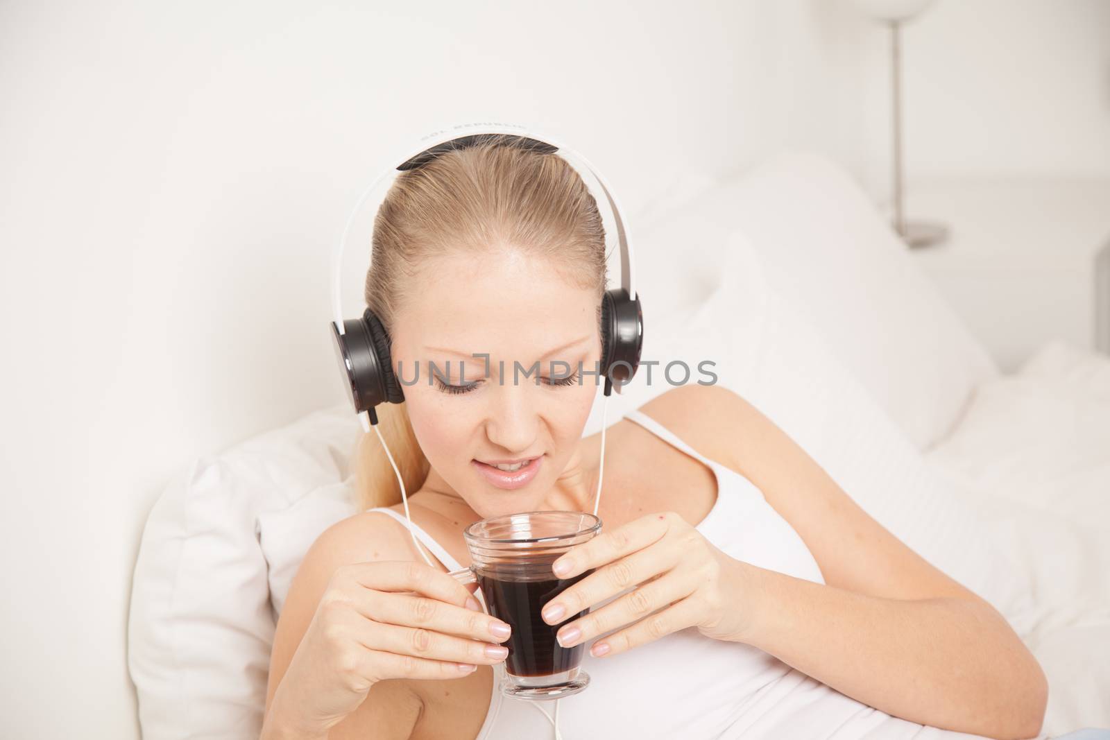 Pretty woman listening to music and drinking coffe