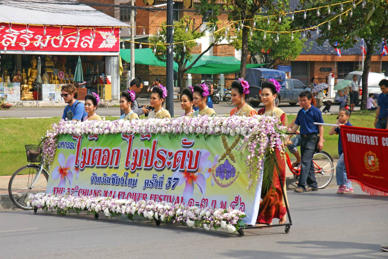 Thai people on the parade in ChiangMai Flower Festival 2013 by mranucha