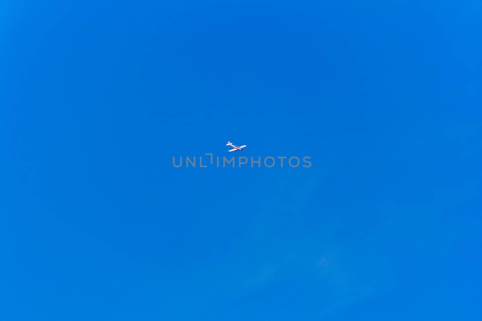 Photo of flying military plane in blue sky