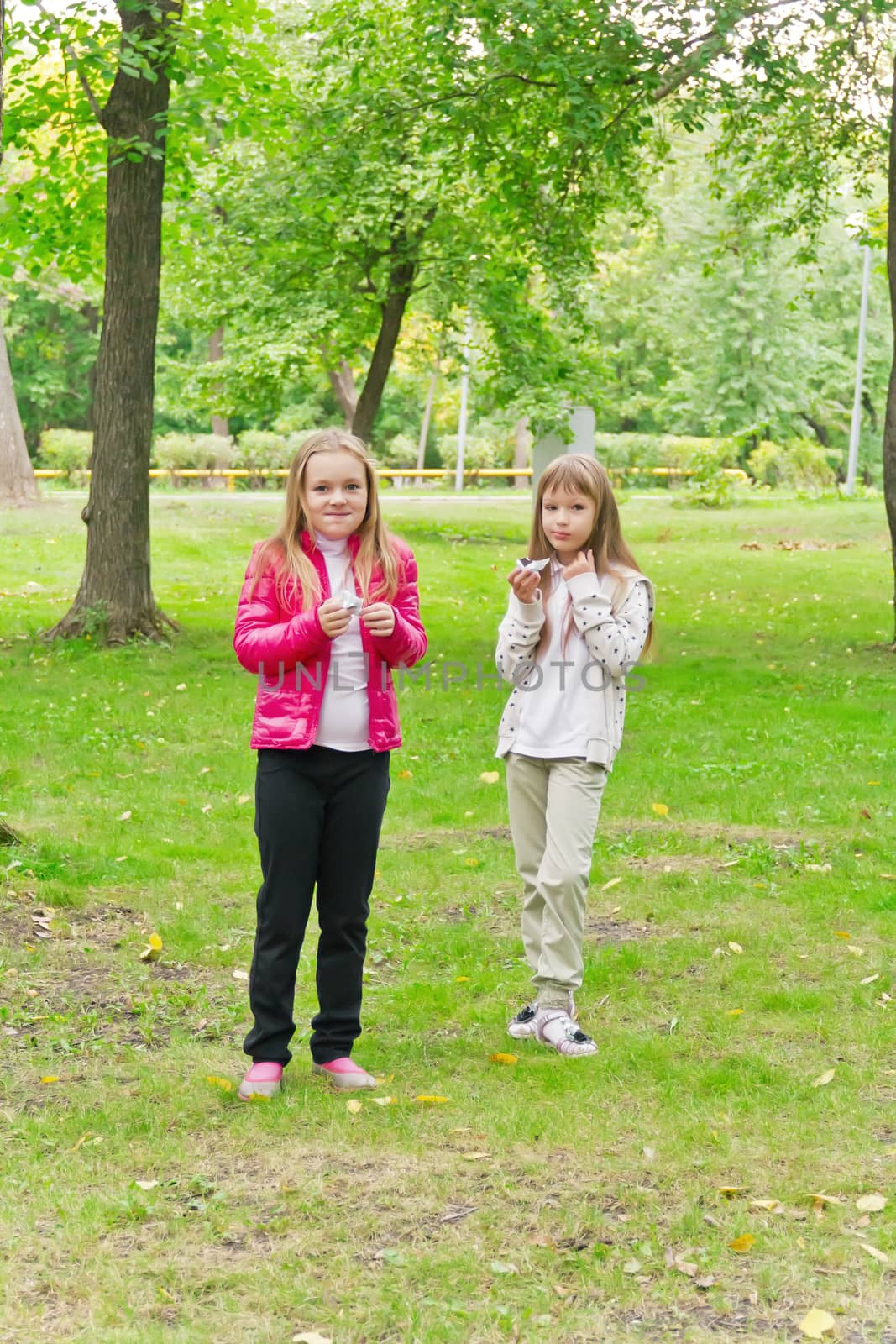 Photo of two eating girls in summer