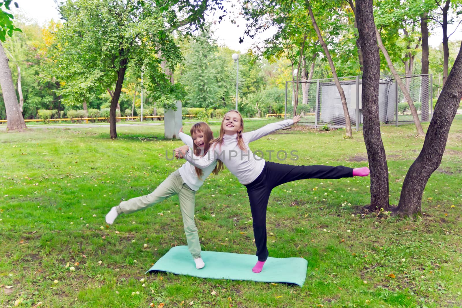 Photo of two playing girls in summer