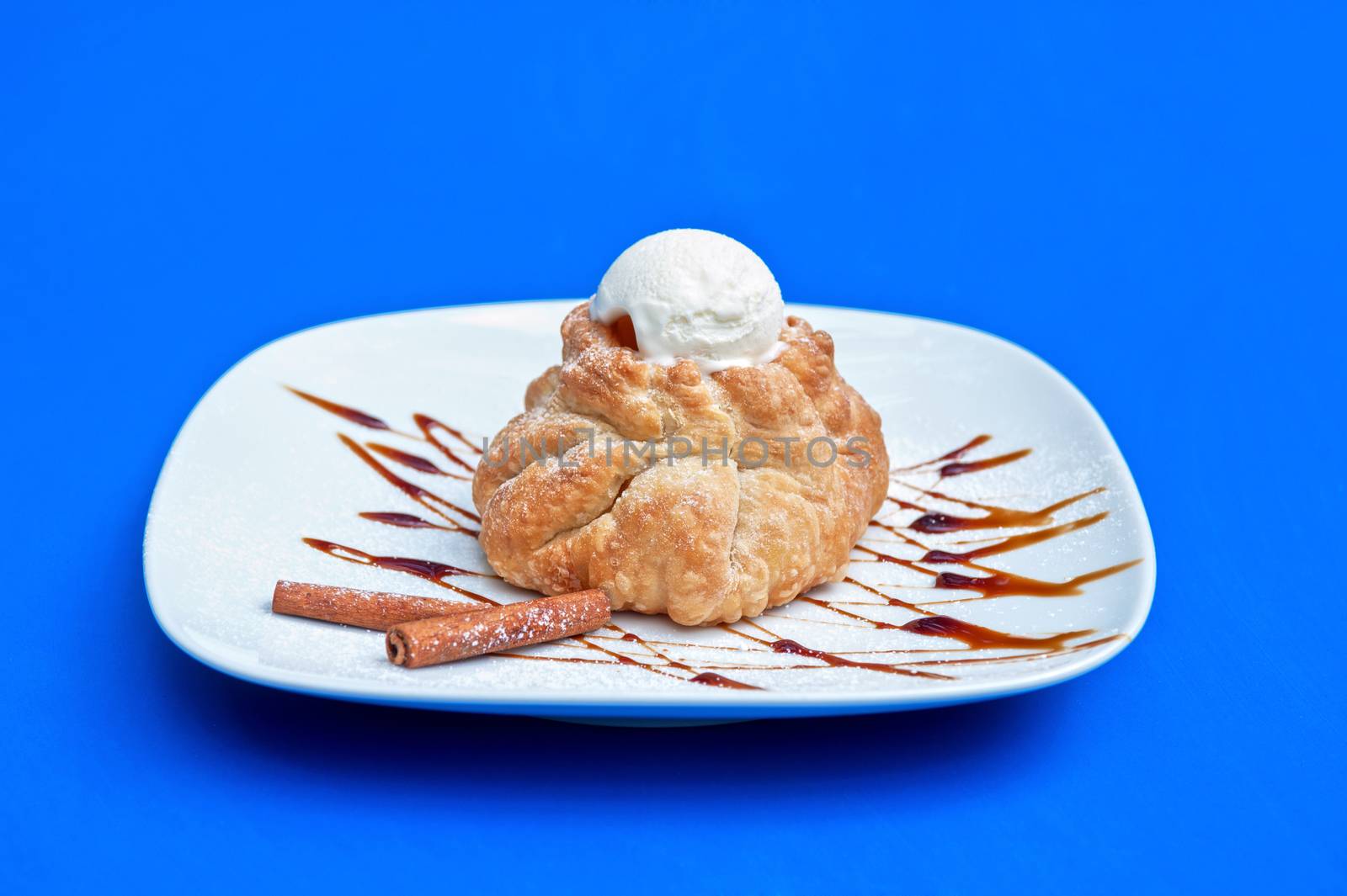 apple strudel with ice cream at blue background