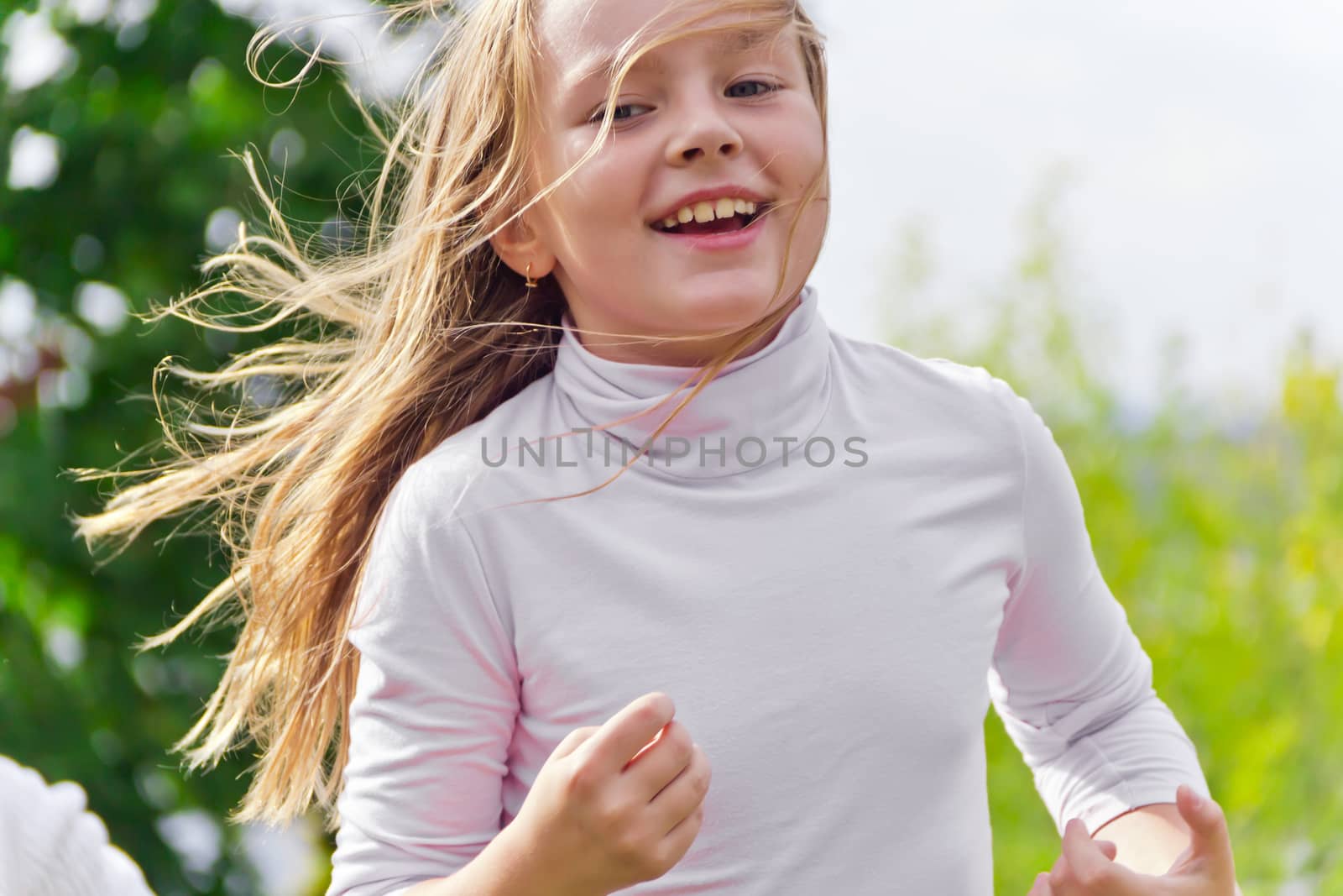 Photo of cute running girl in summer