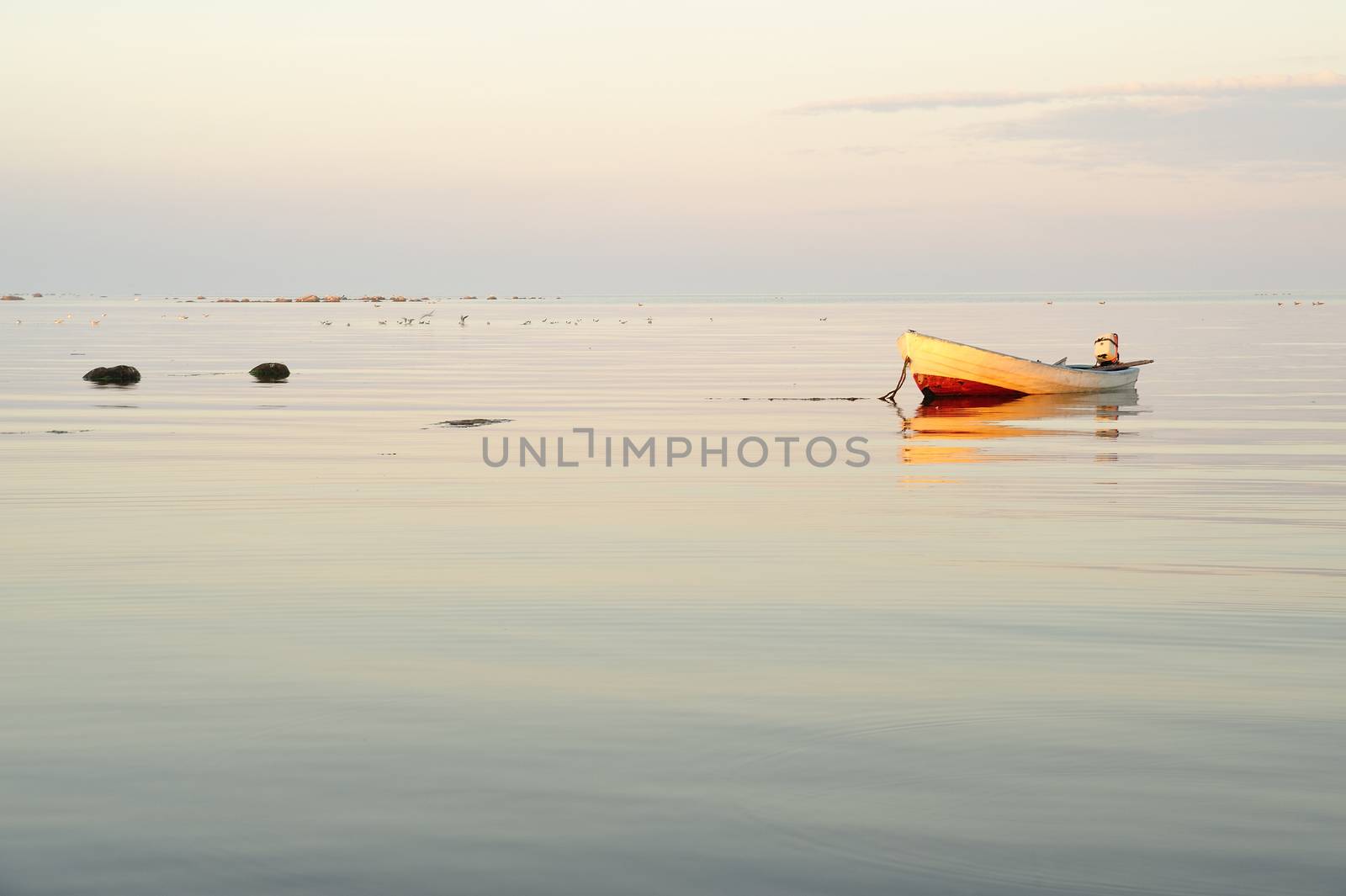 Boat on Calm Lake at Sunrise.