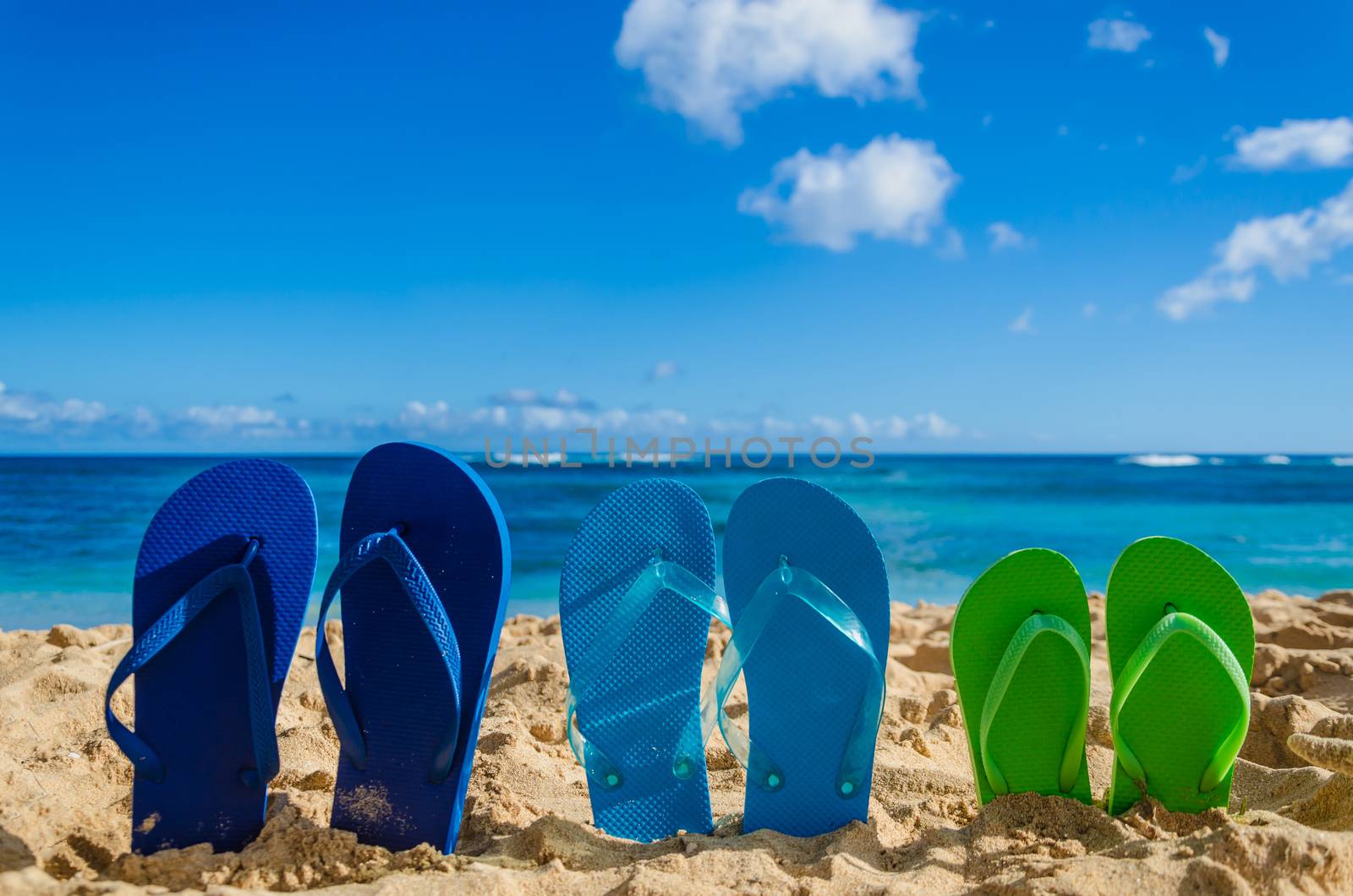 Colorful flip flops on the sandy beach in Hawaii, Kauai