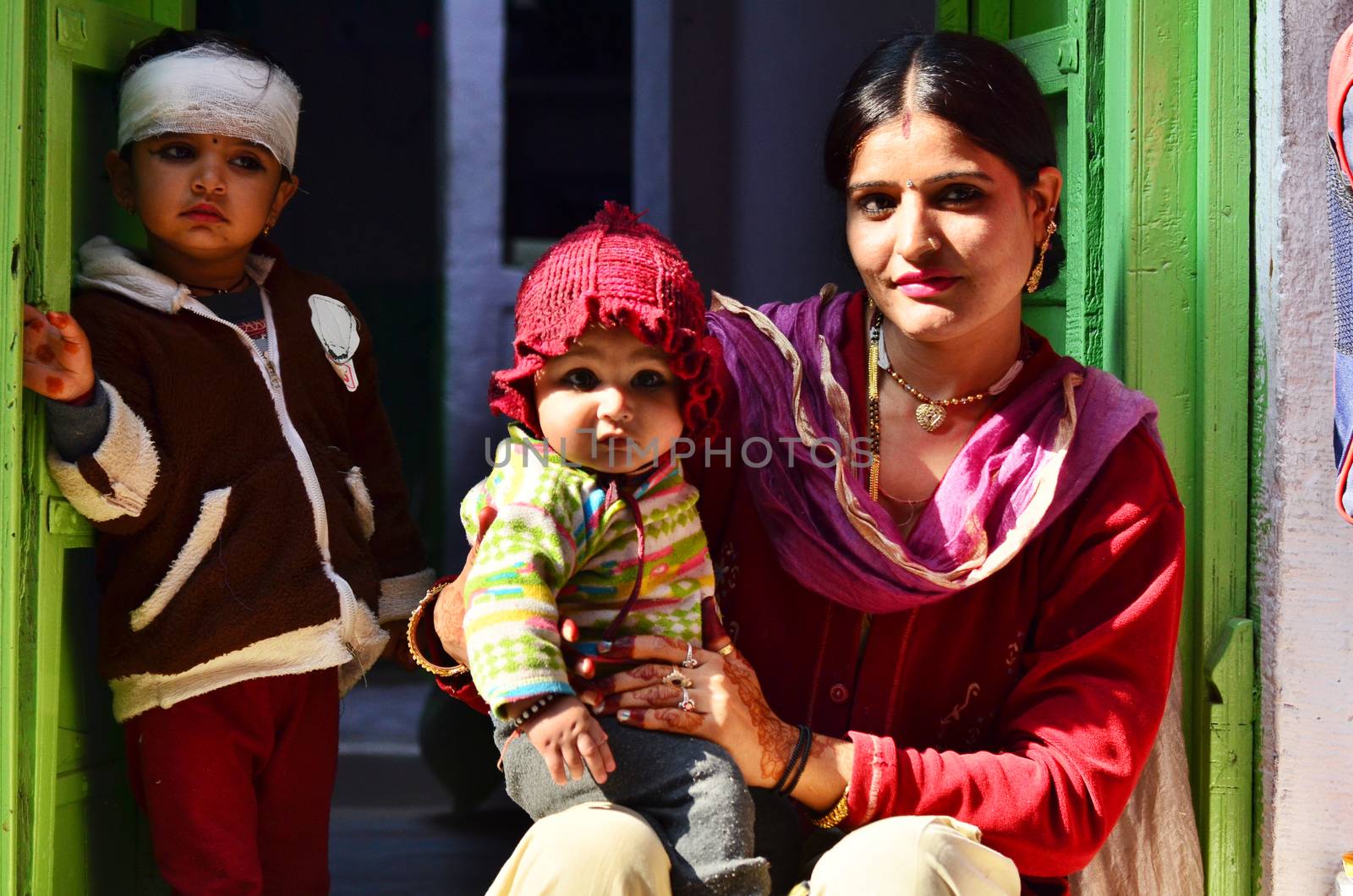 Jodhpur, India - January 1, 2015: Indian proud mother poses with her children in Jodhpur, India. Jodhpur is the second largest city in the Indian state of Rajasthan with over 1 million habitants.