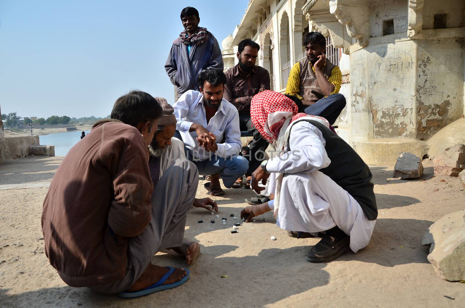 Jodhpur, India - January 1, 2015: Indian men play traditional street game in Jodhpur by siraanamwong