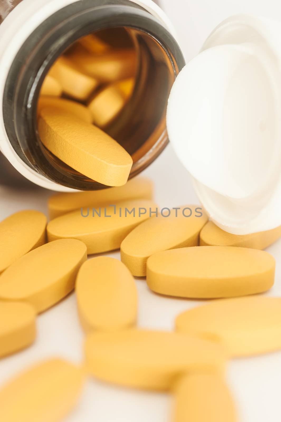 Vitamin in capsule spilling out of a bottle, Vitamin for health