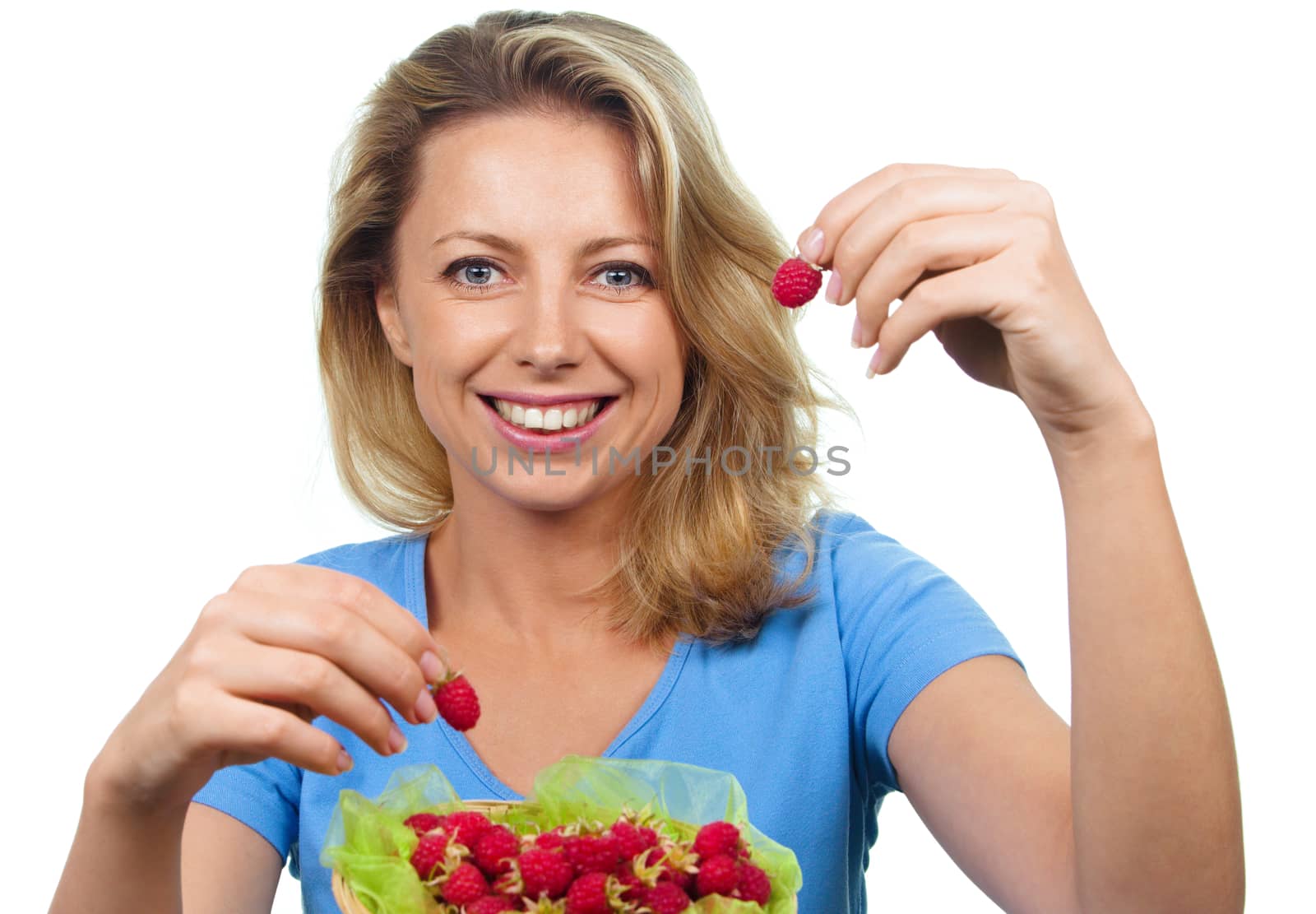 Close up of smiling woman holding raspberries isolated on white