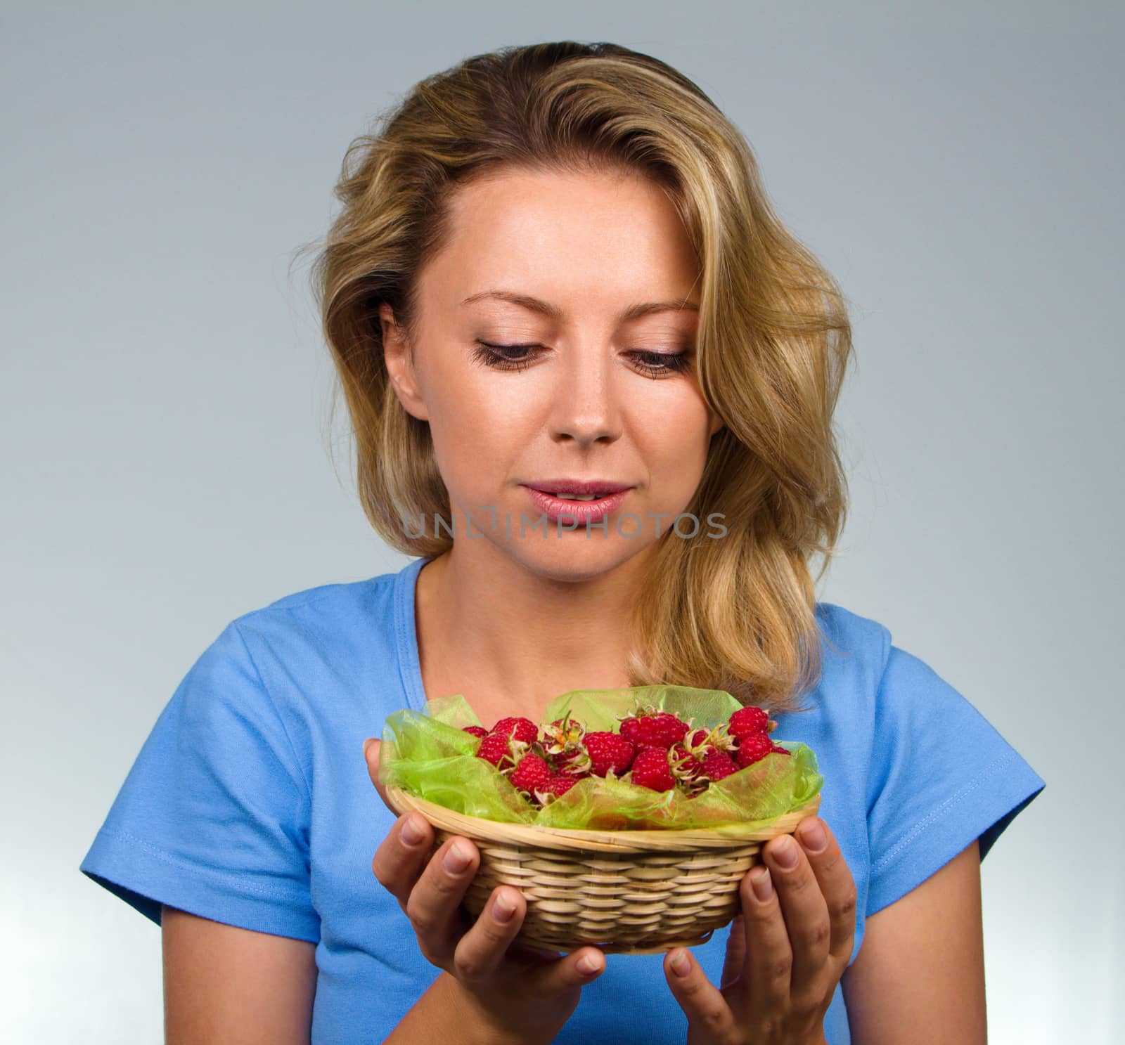 Close up of woman holding raspberries