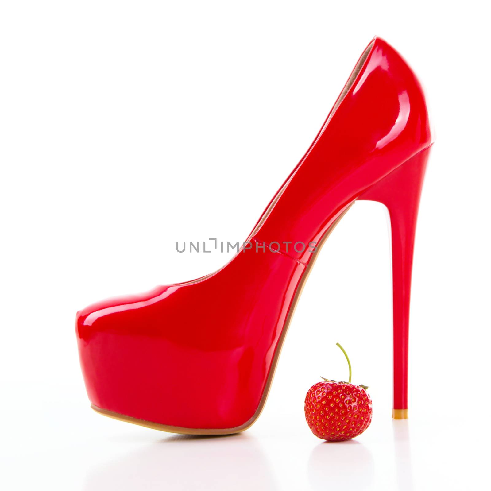 Red high heel women shoe with strawberry on white background