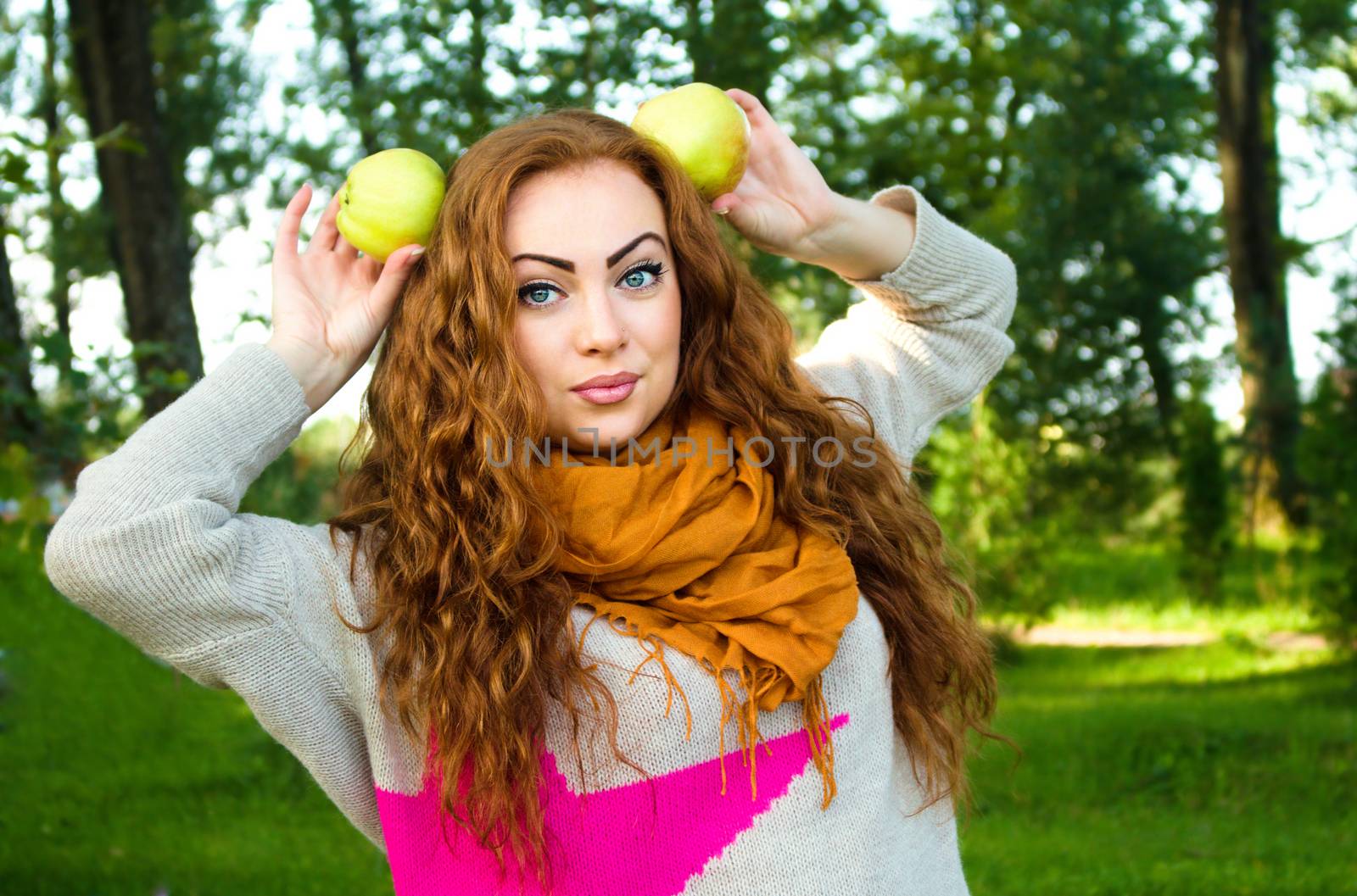 Beautiful ginger-haired woman with apples, outdoors portrait by id7100