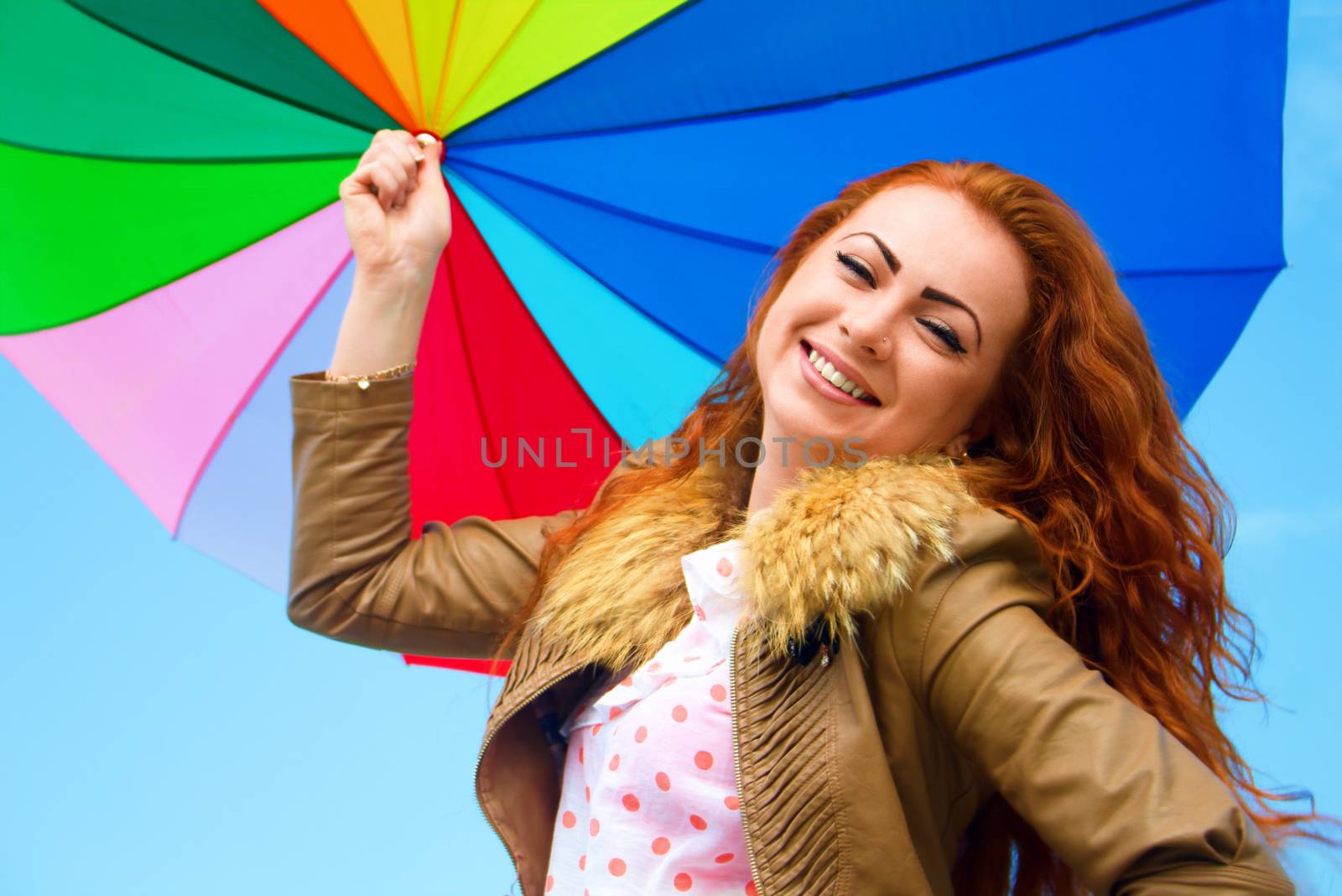 Portrait of a pretty woman with colorful umbrella, outdoor shots