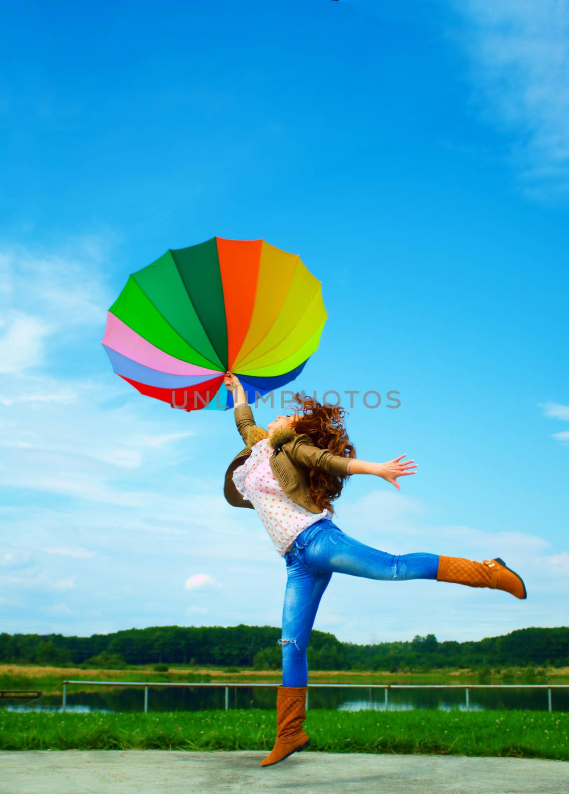 Multicolor umbrella woman jump to sky, outdoor