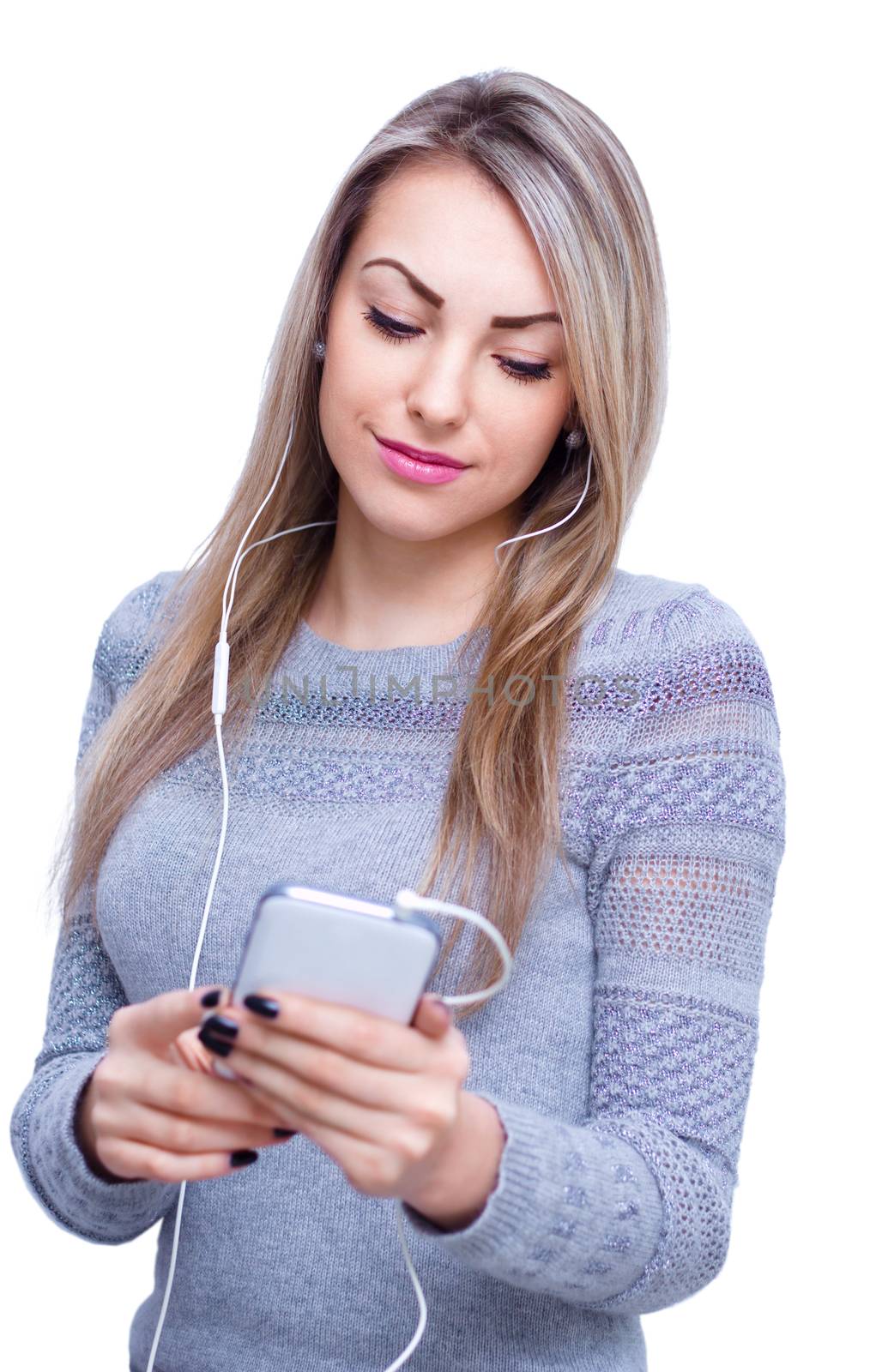 Closeup portrait of lovely young woman enjoying music using headphones, isolated over white
