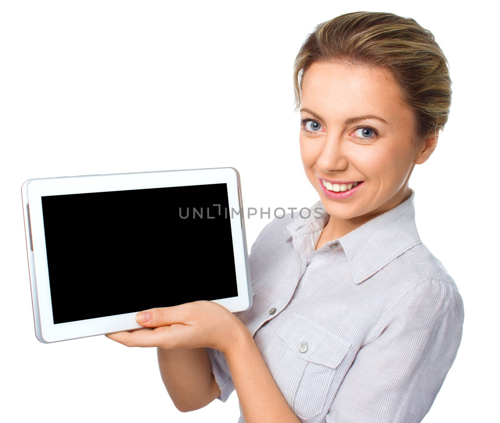 Young cheerful woman is showing blank tablet, isolated over white