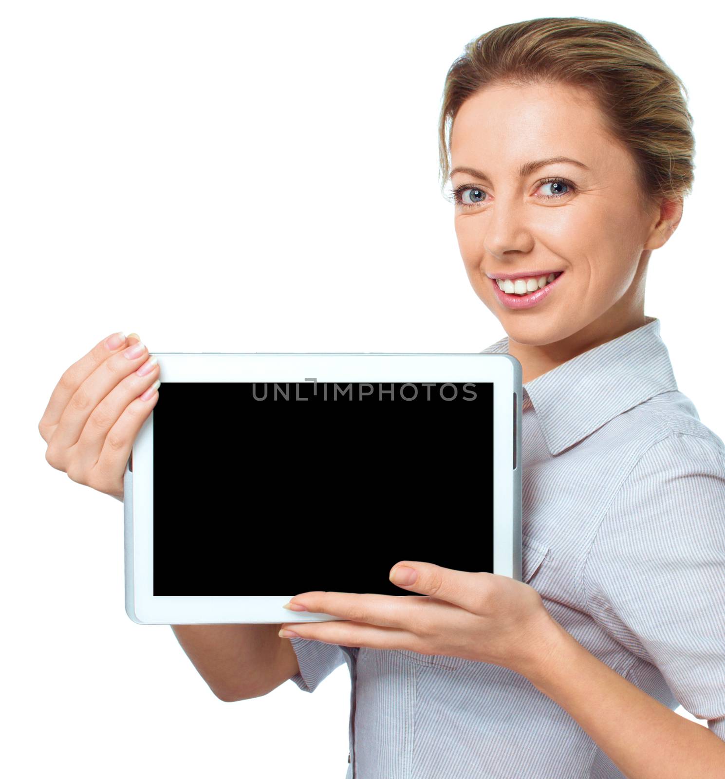 Young cheerful woman is showing blank tablet, isolated over white