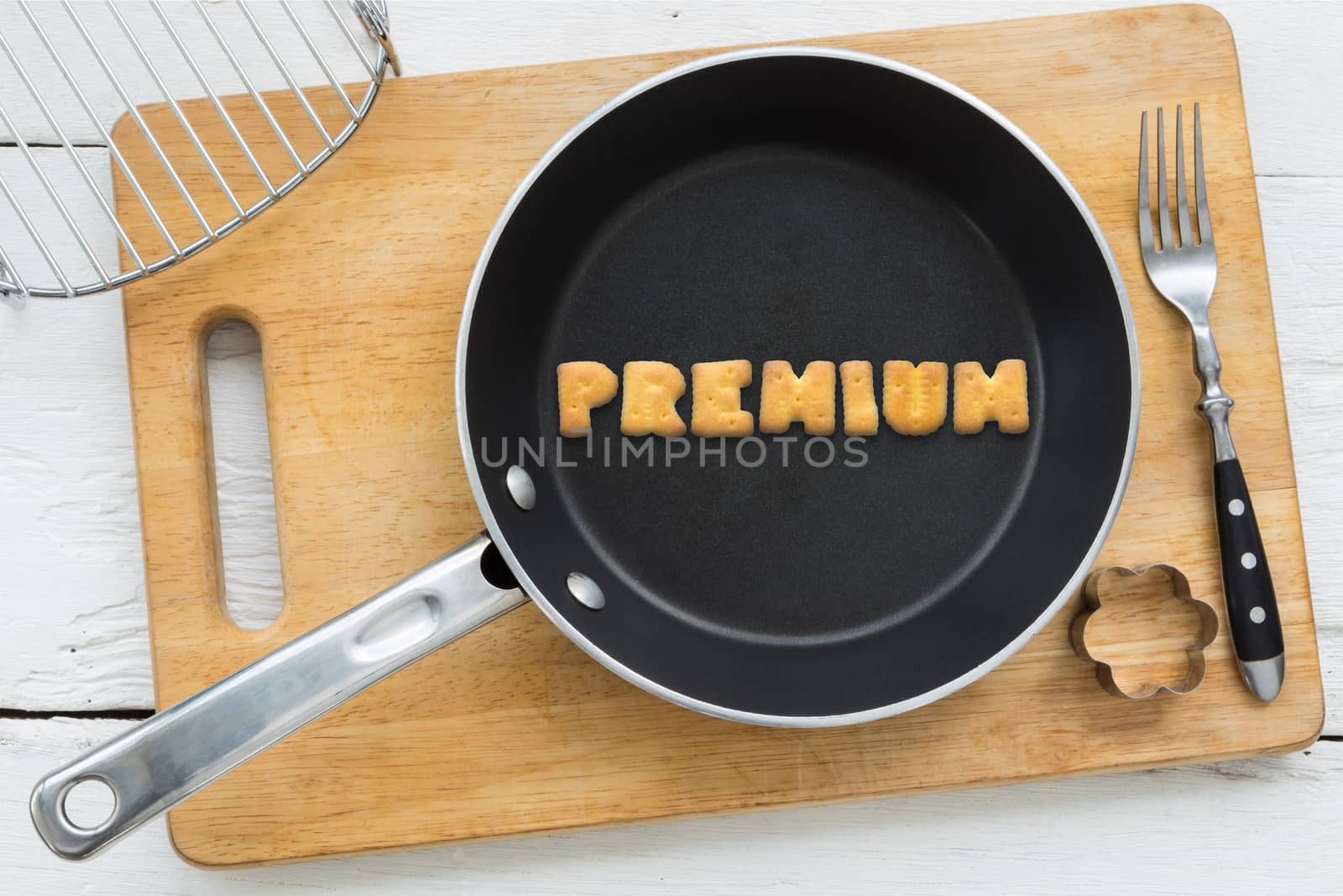Letter cookies word PREMIUM and kitchen utensils by vinnstock