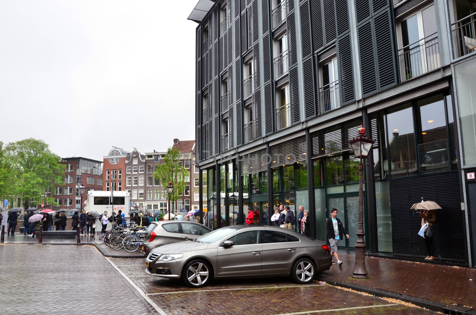 Amsterdam, Netherlands - May 16, 2015: Tourists stand in a queue to Anne Frank House Museum on May 16, 2015. The Anne Frank House Museum is one of Amsterdam's most popular museums opened in 1960.