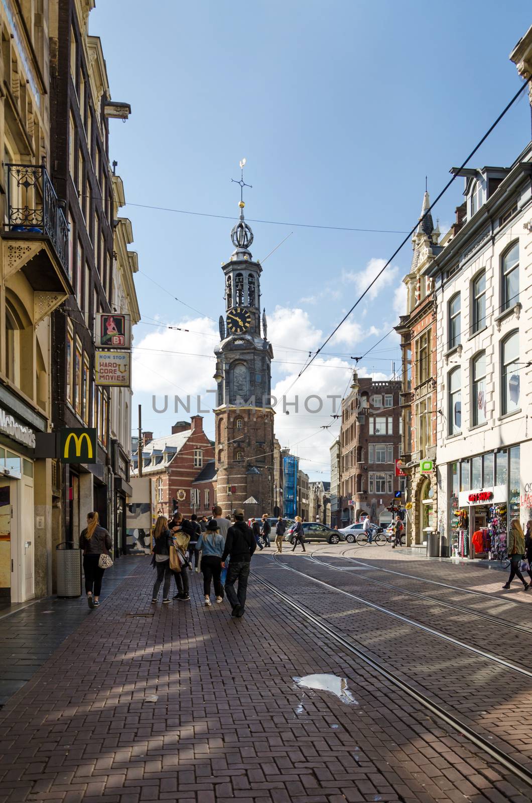 Amsterdam, Netherlands - May 8, 2015: People at The Munttoren (Mint Tower) Muntplein square in Amsterdam, This tower was once part of one of the three main medieval city gates. 