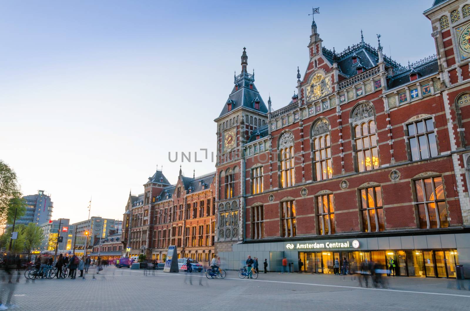 Amsterdam, Netherlands - May 8, 2015: People at Amsterdam Central Train Station on May 8, 2015 in Amsterdam, Netherlands. Amsterdam Central Station is used by 250,000 passengers a day.