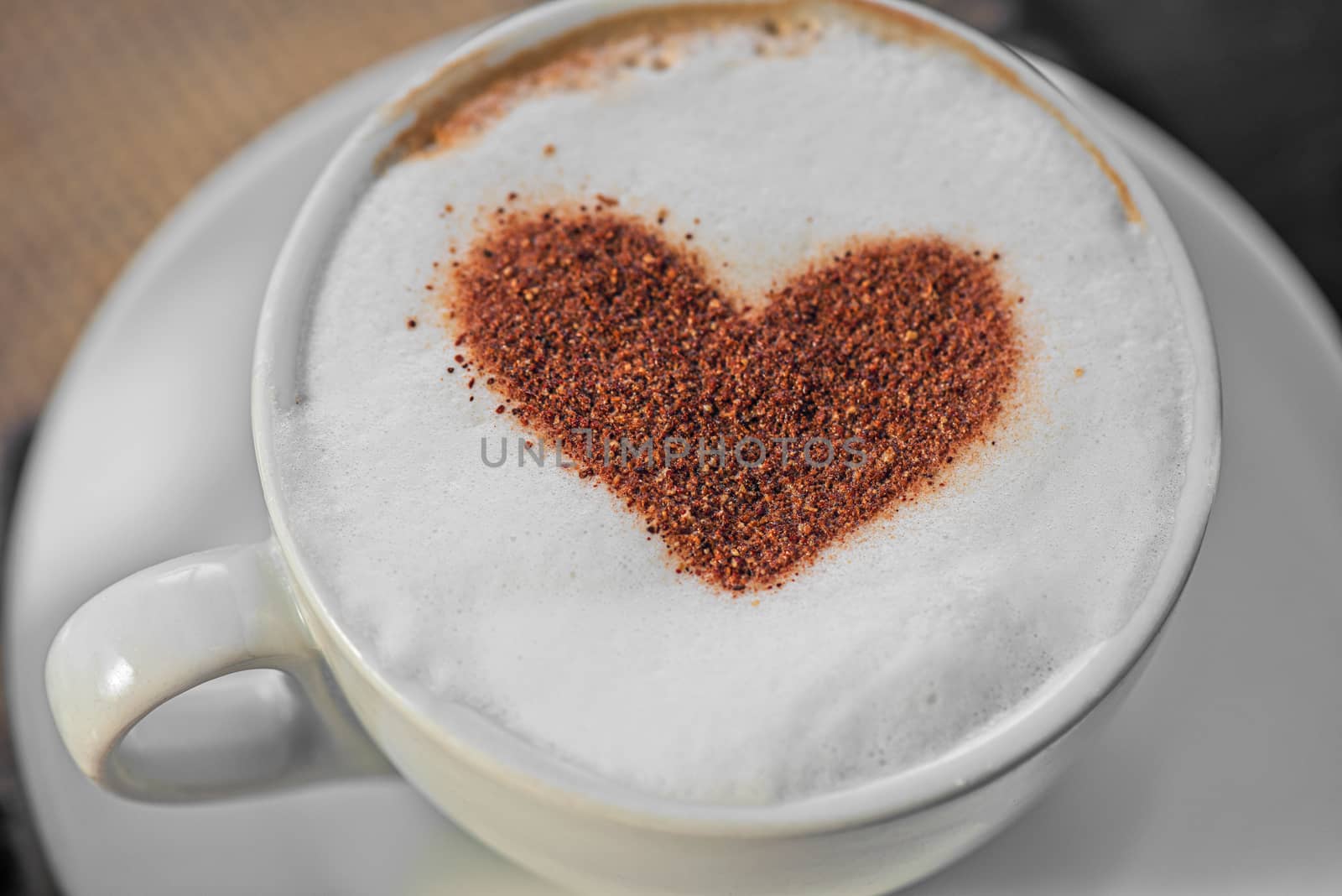 Coffee cup with milk and heart shape