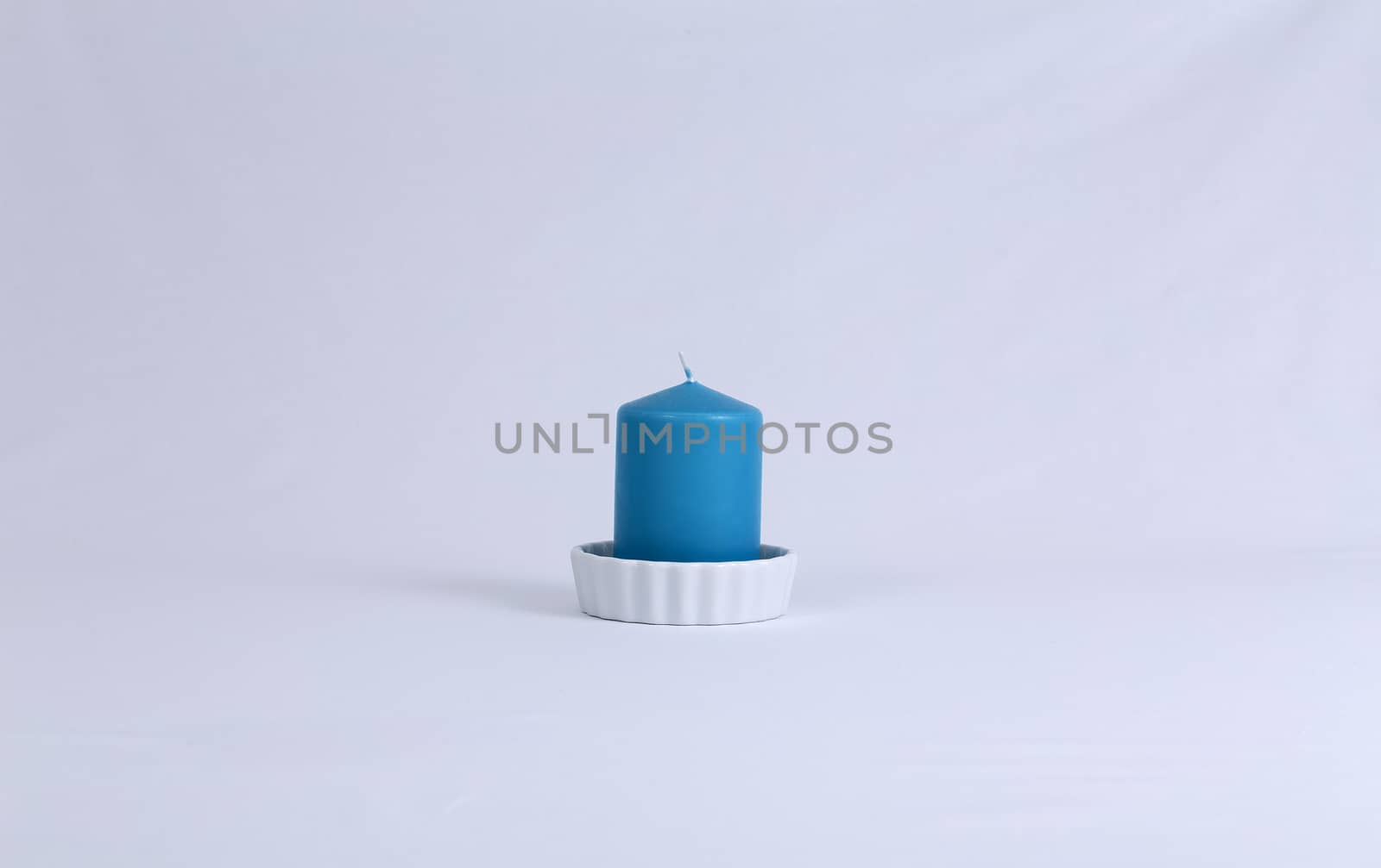 An blue isolated candle in a plate