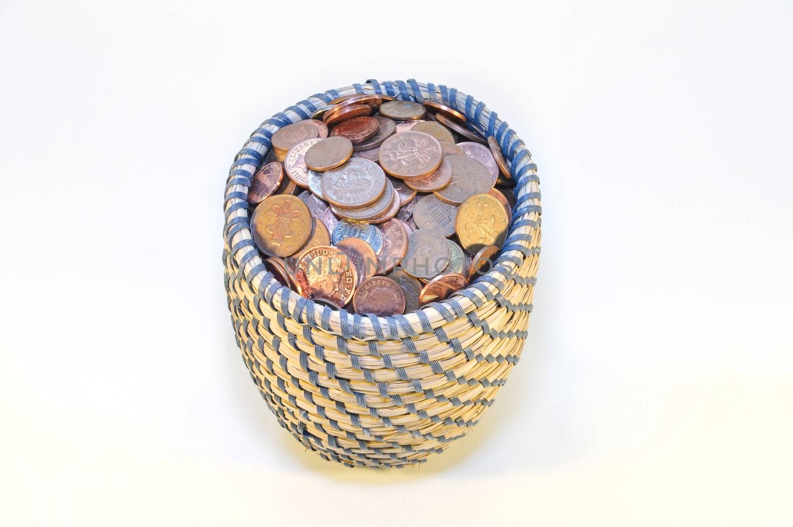 coins in basket and british banknotes