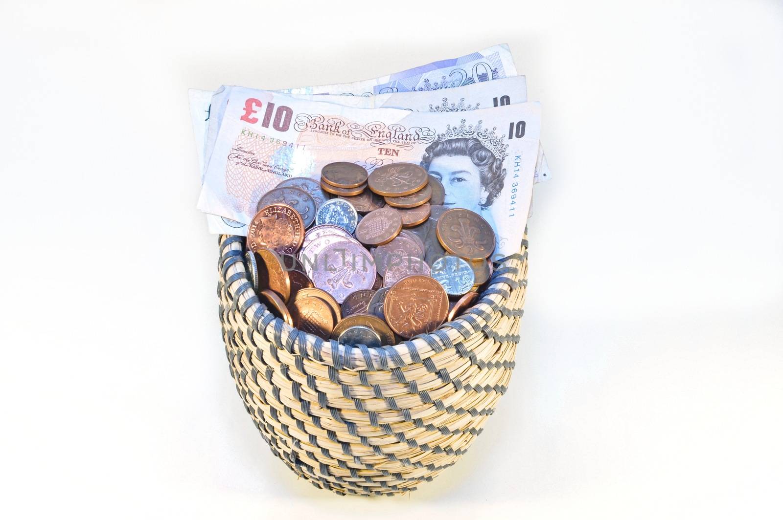 coins in basket and british banknotes