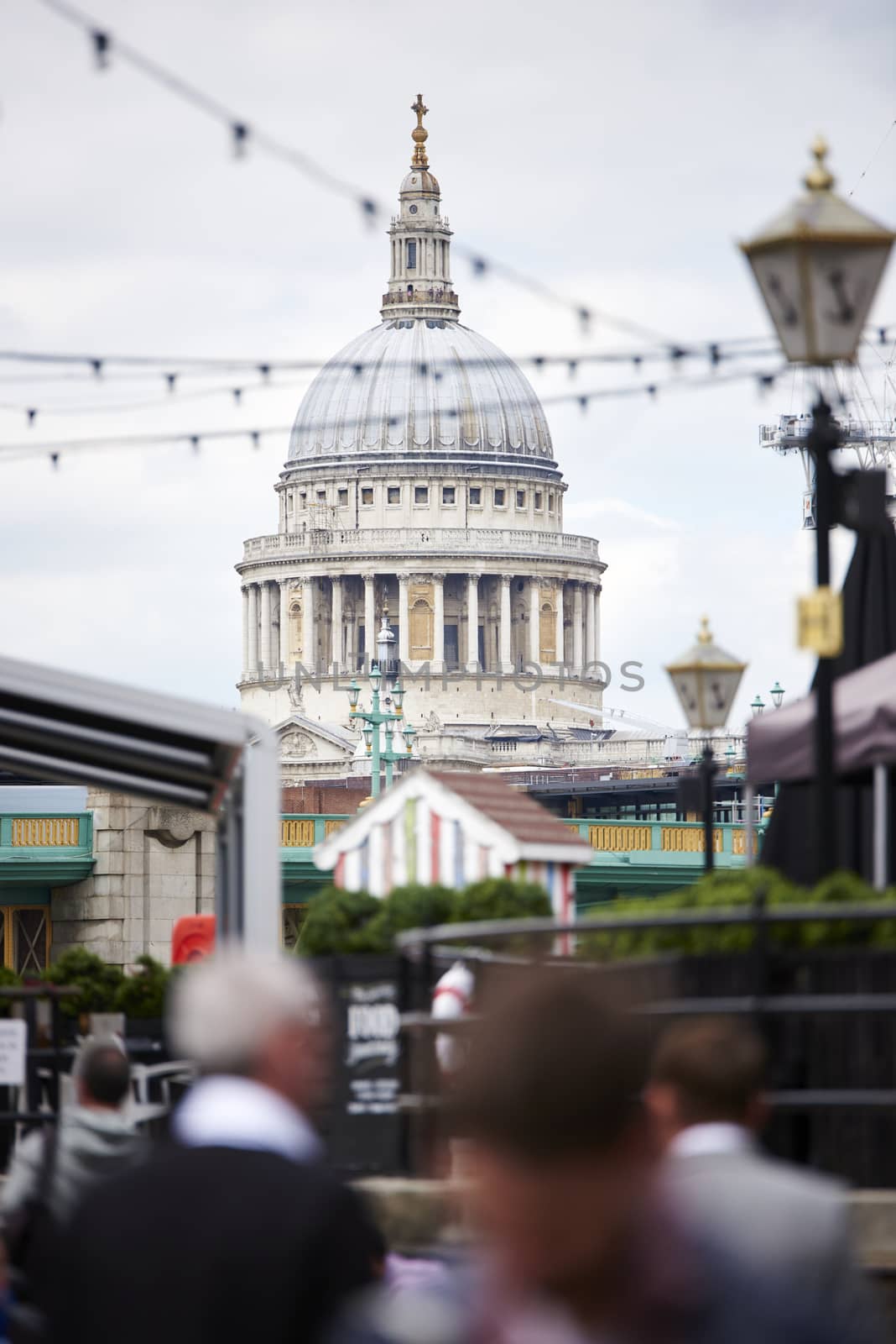 LONDON, UK - JUNE 23: Dome of Saint Paul's cathedral seen from Blackfriars, with blurred people in the foreground. June 23, 2015 in London.