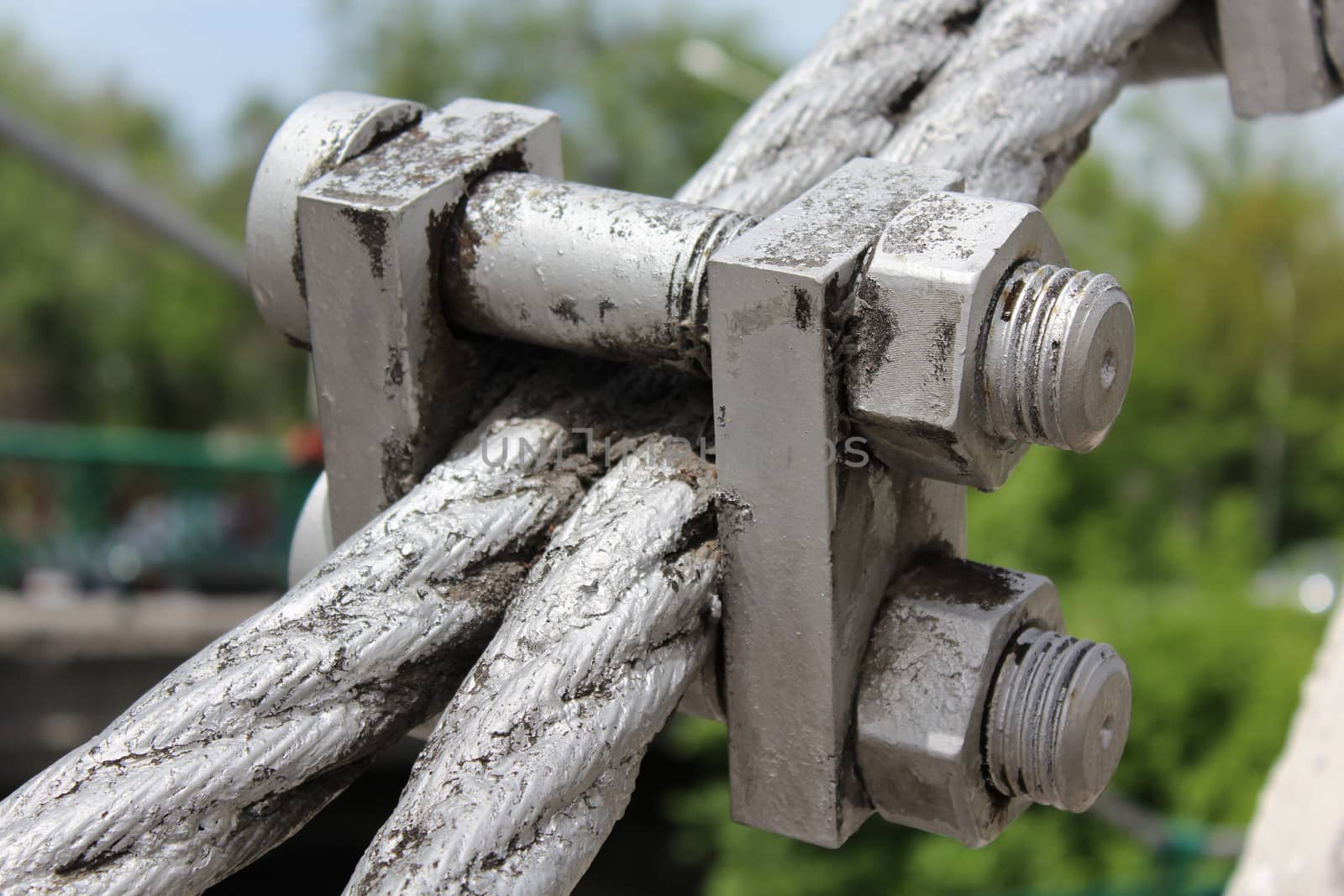 Large bolts, nuts and steel wire rope. Elements of fastening of bridge.