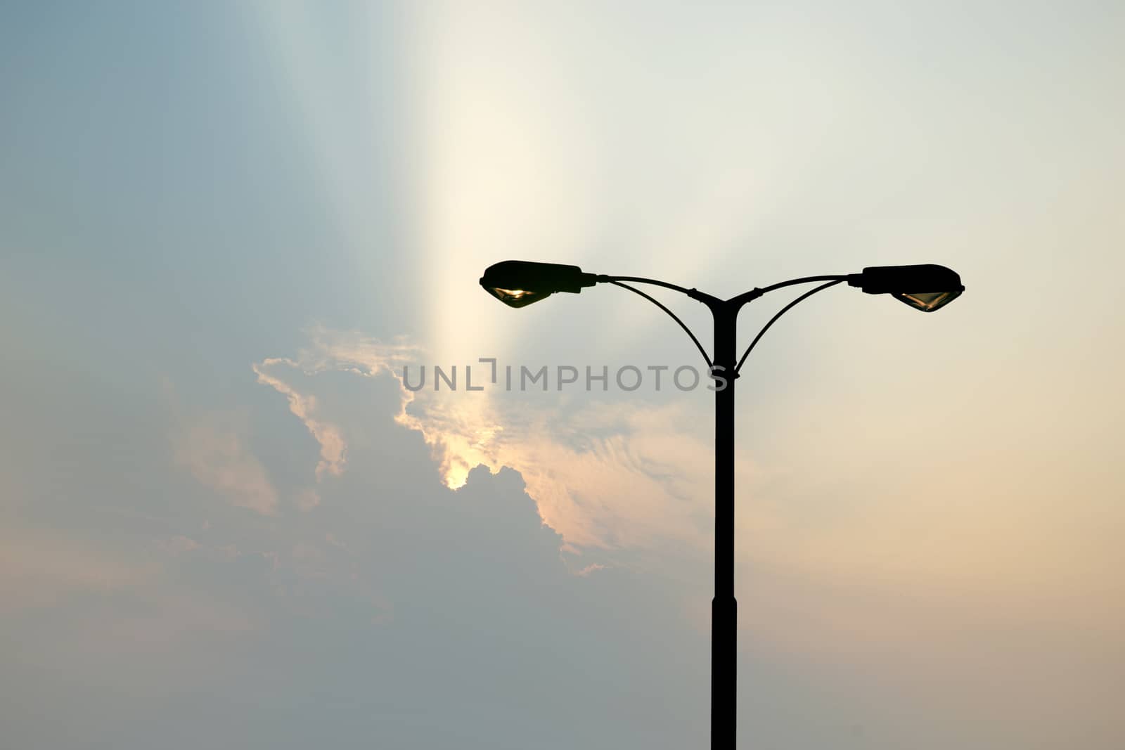 silhouette of streetlight with beautiful sunbeam background