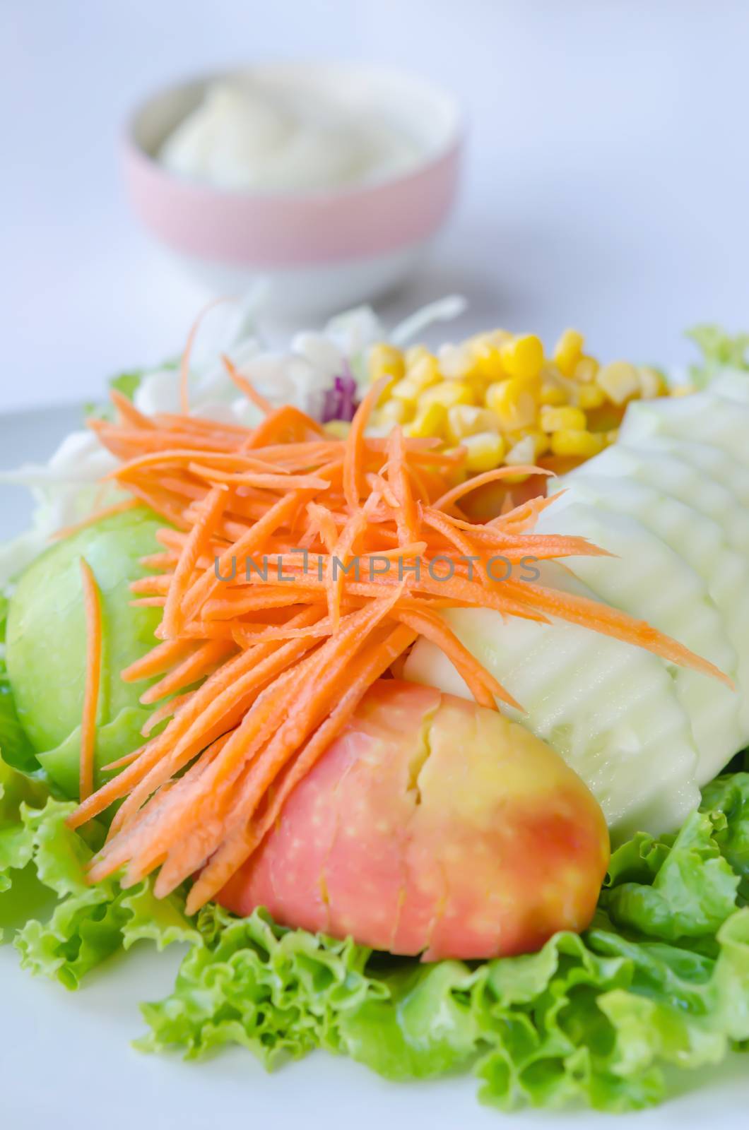 fresh salad with fruits and mixed vegetable on dish served with white cream sauce