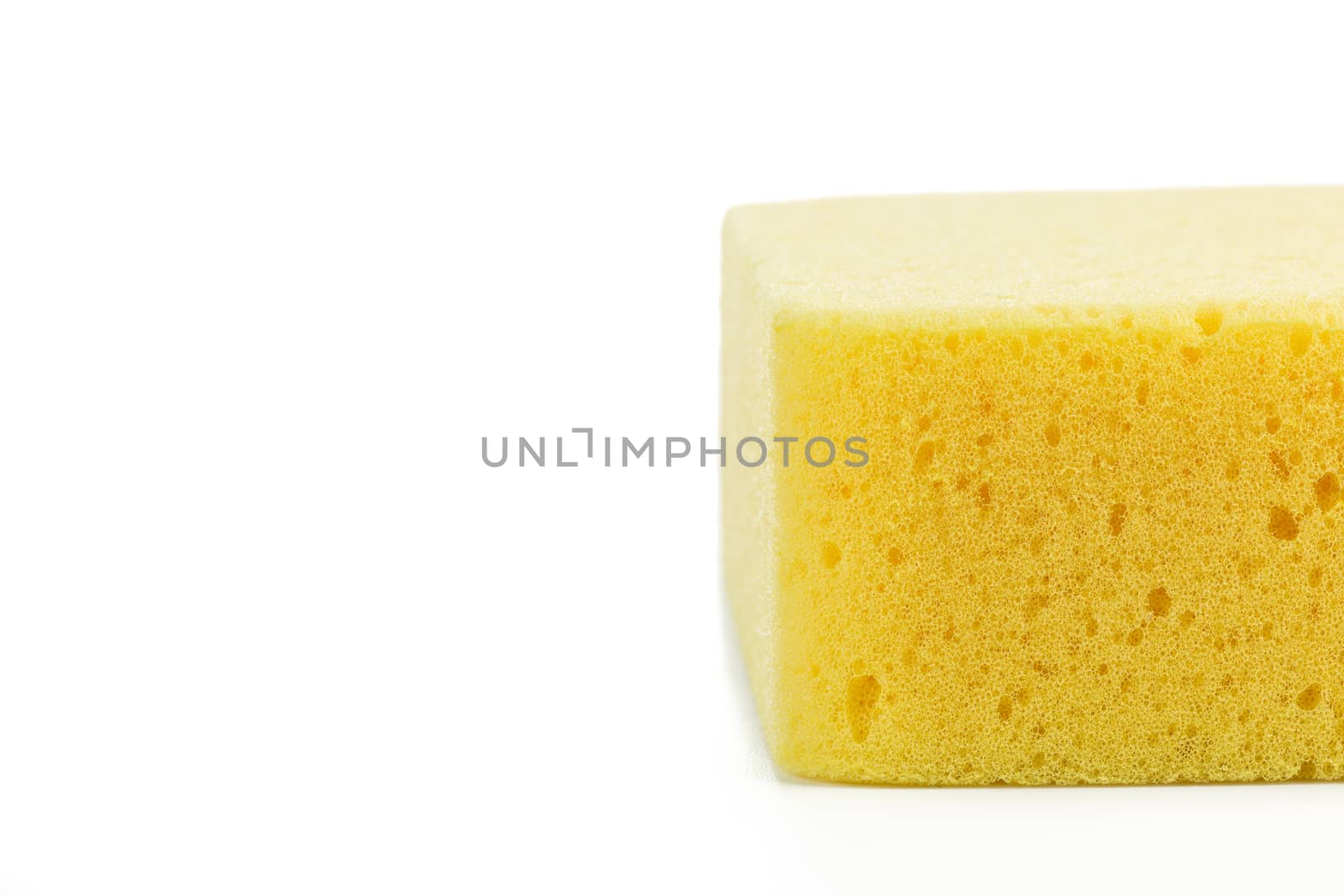 Yellow Sponge Close-up with space on white background by urubank