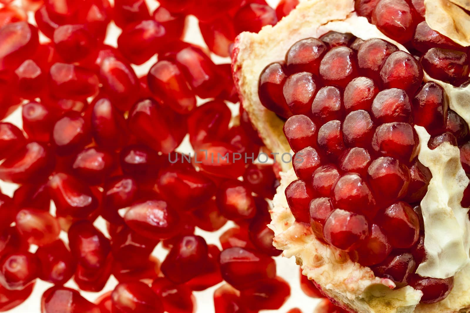   photographed by a close up opened red mature pomegranate
