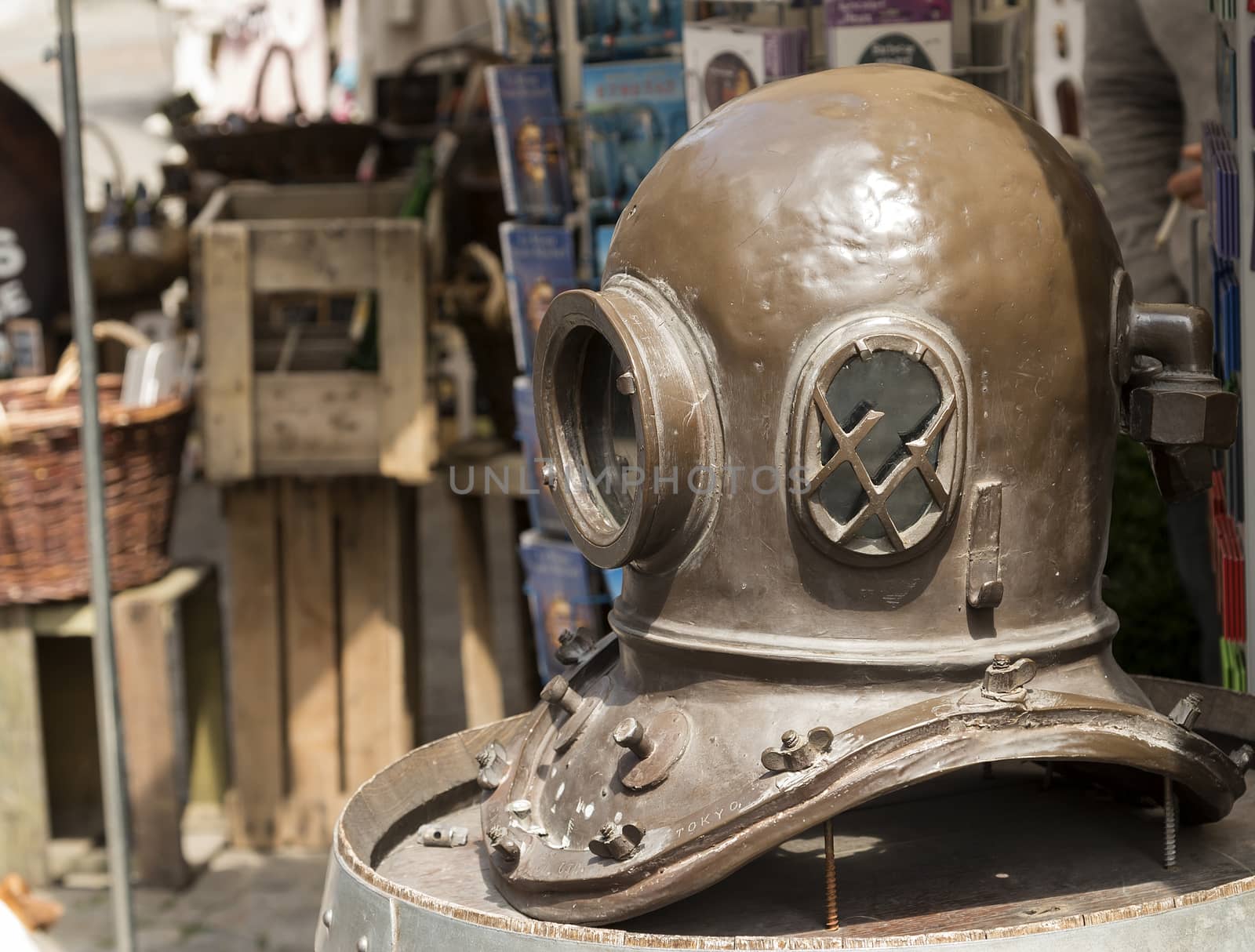 An old divers helmet outside a shop to attract customers