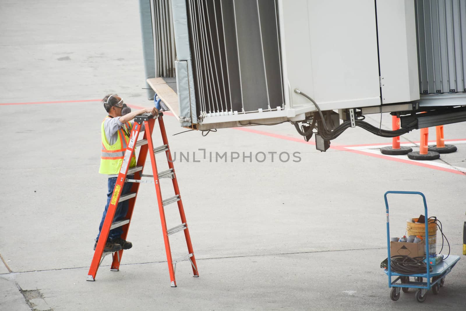 Airport worker prepares passenger ramp