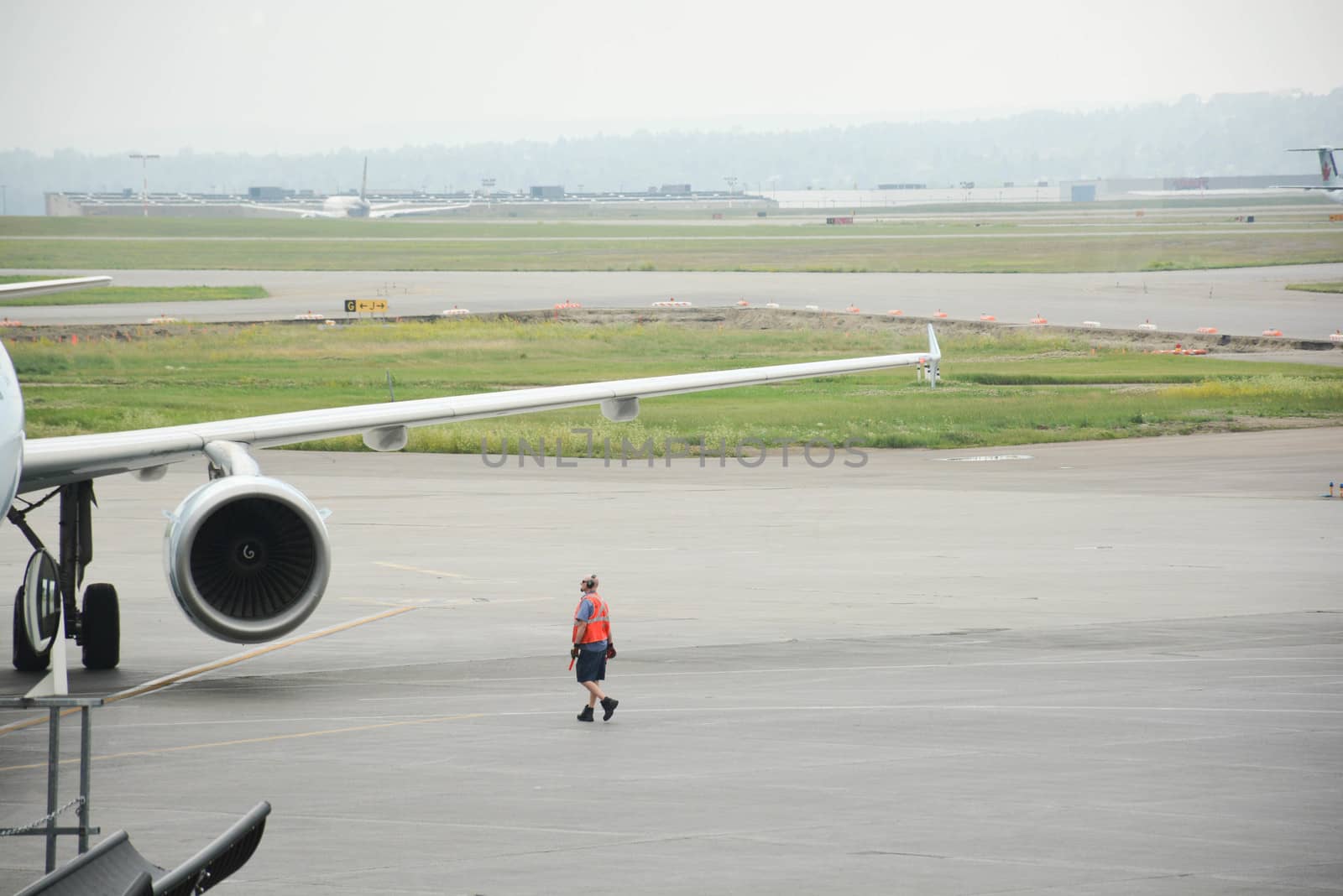 Airport worker attends docked airplane
