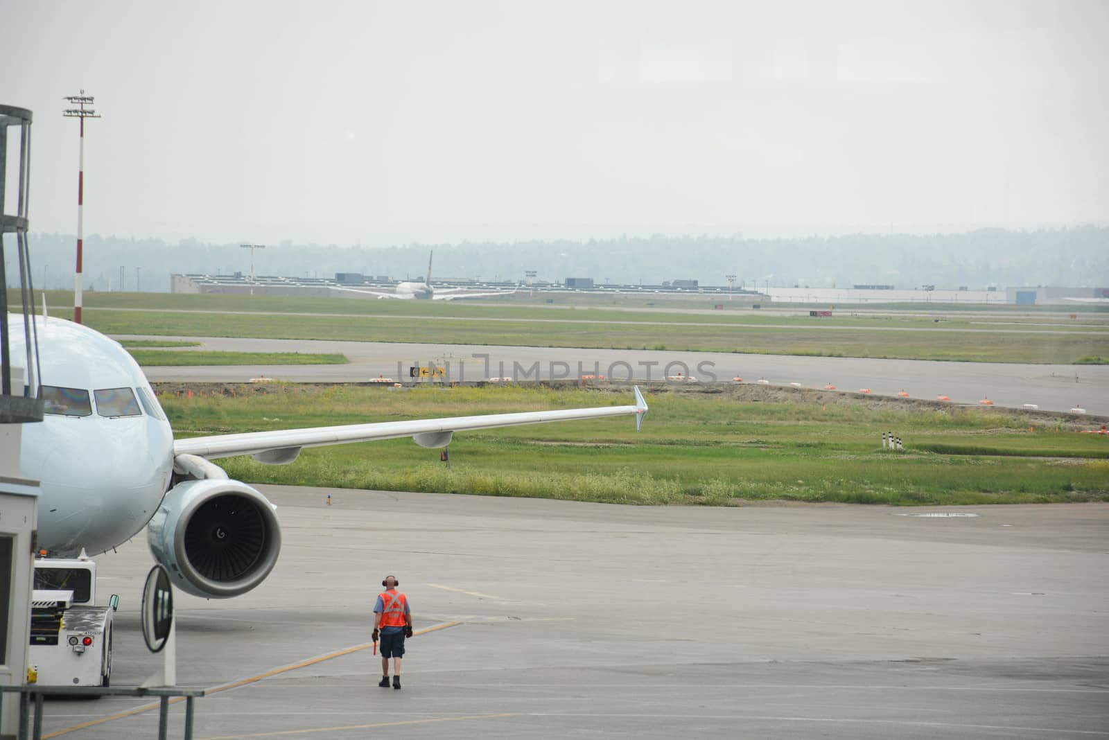 Airport worker attends a passenger plane