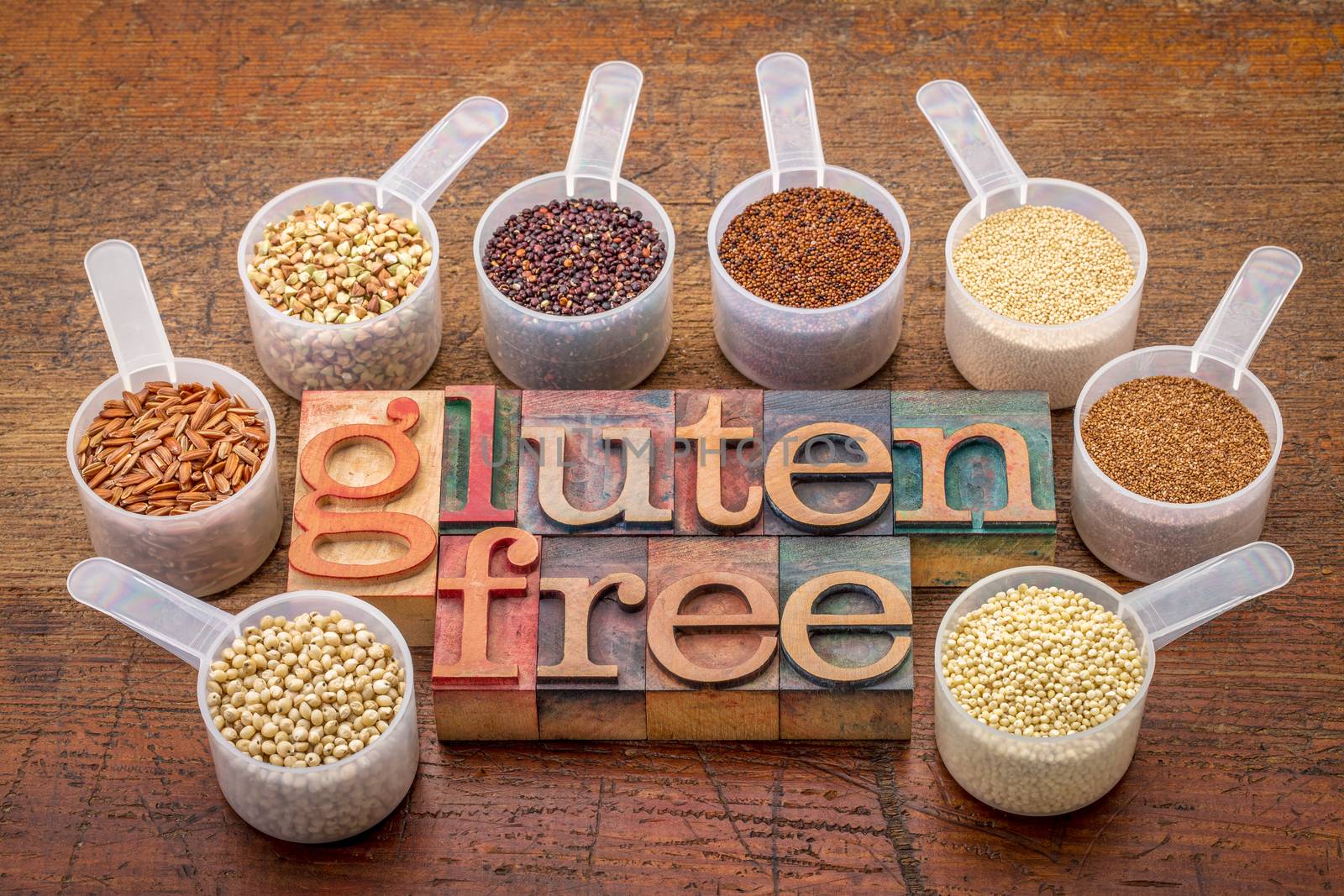 gluten free grains (quinoa, brown rice, kaniwa, amaranth, sorghum, millet, buckwheat, teff) - measuring scoops with a text in letterpress wood type