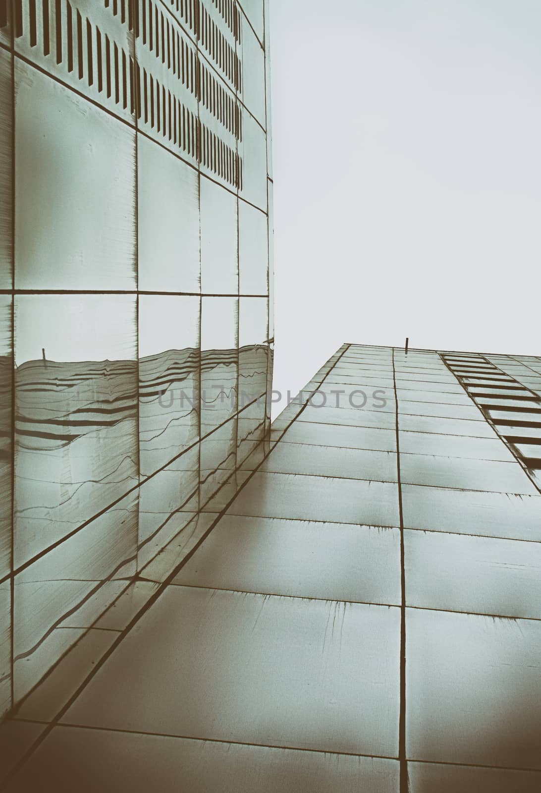 Photograph of a pair of metal buildings from a bottom perspective